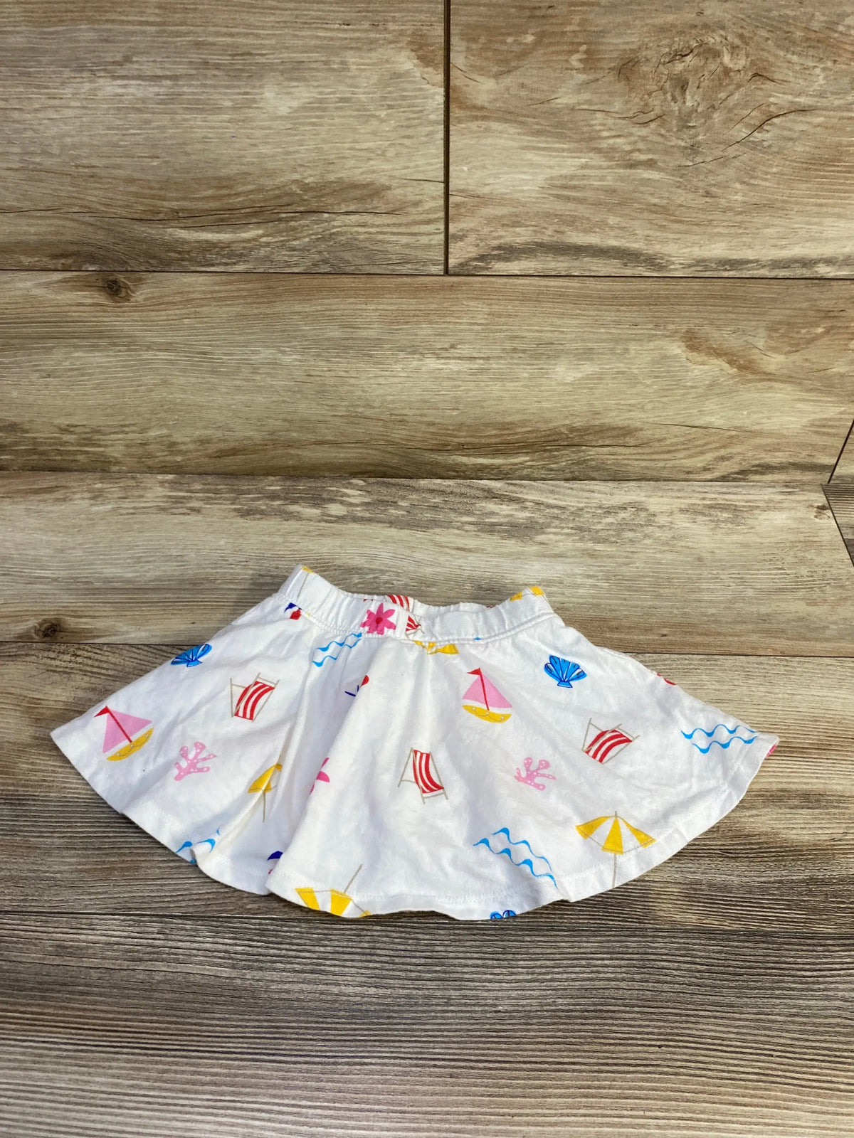 Baby Gap white pull-on skort with colorful nautical beach print on wooden background