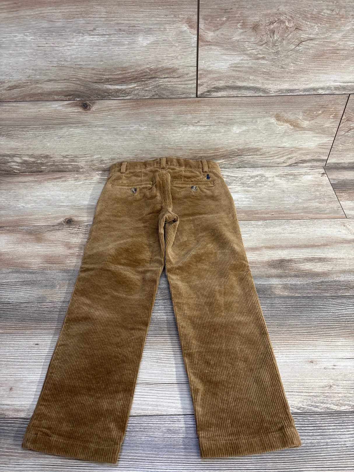 Back view of Ralph Lauren corduroy pants (Jodphur Tan, size 4T) showing back pockets and straight legs on wood floor