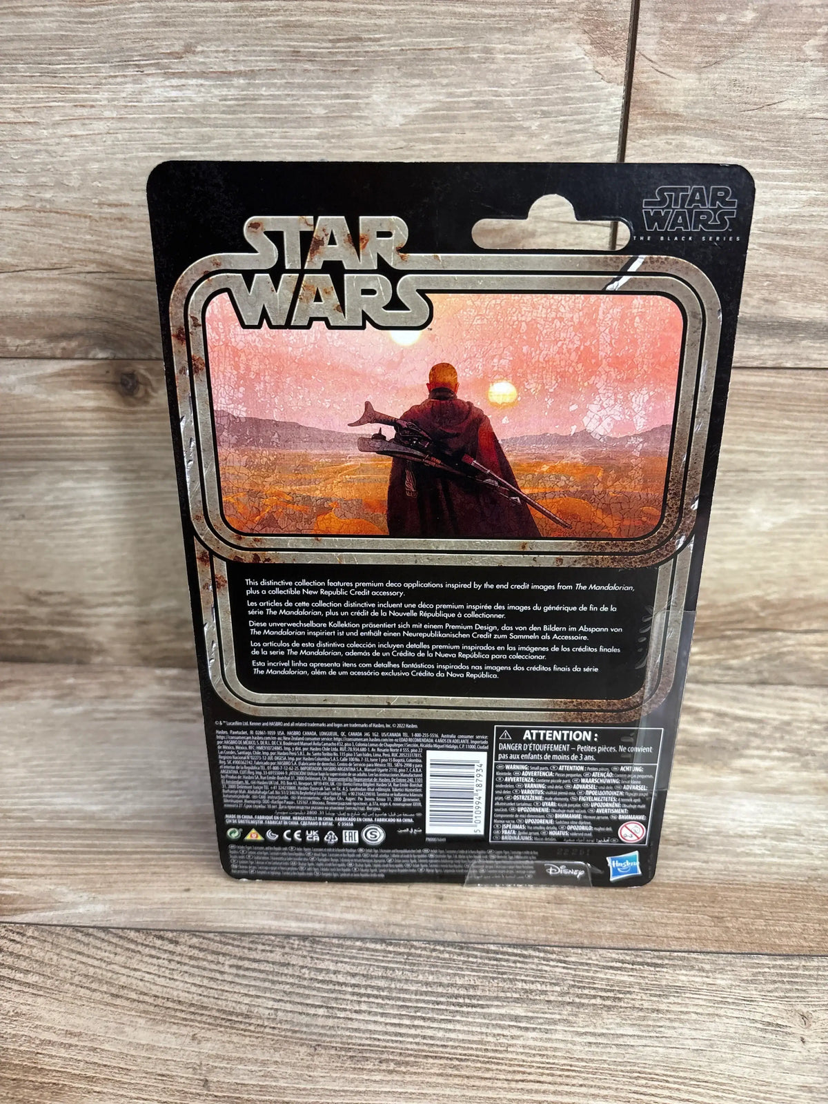 Rear of Boba Fett action figure packaging showing STAR WARS logo and Mandalorian sunset with twin suns