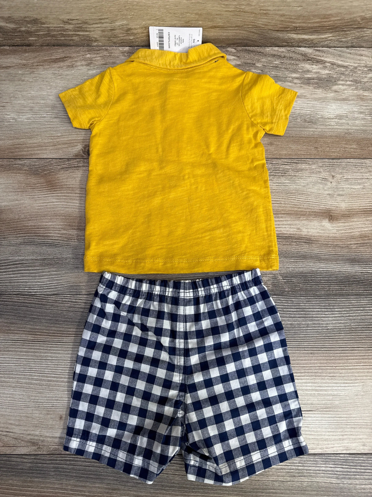 Flat lay of yellow Carter's polo shirt (back) and navy-and-white gingham shorts showcasing elastic waist on wood background