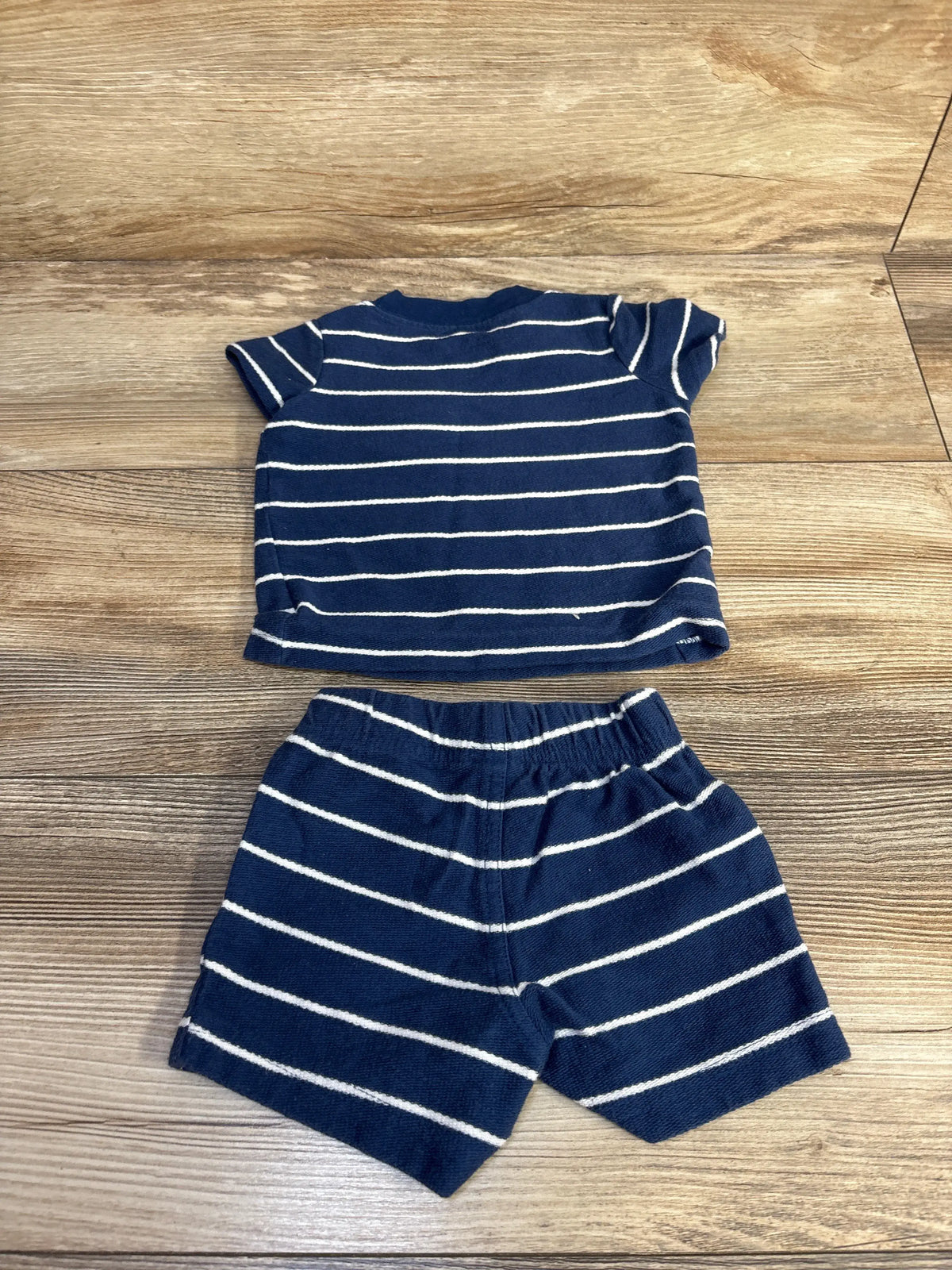 Front view of Just One You navy striped shirt and shorts set showcasing its coordinated two-piece design on a wooden floor