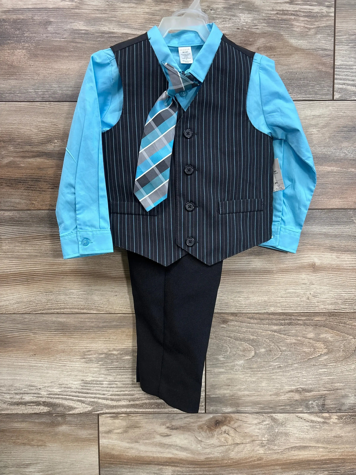 Front view of boys 4-piece blue vest suit (3T) with striped vest, turquoise shirt, tie, on wood floor