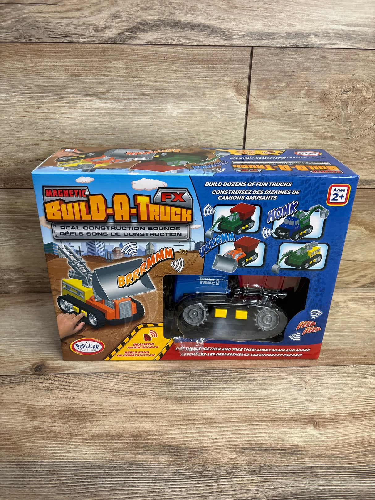 Front of Magnetic Build-A-Truck FX box showing blue tracked truck through window and packaging text Real Construction Sounds