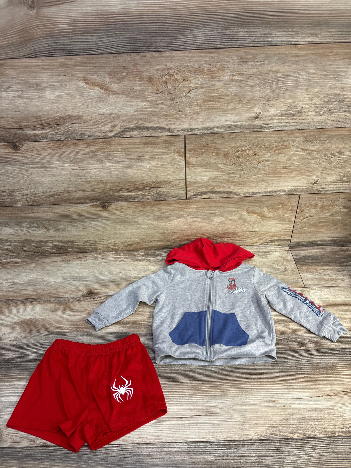 Children's Spider-Man outfit with grey zip-up hoodie with red hood and red shorts with white spider logo