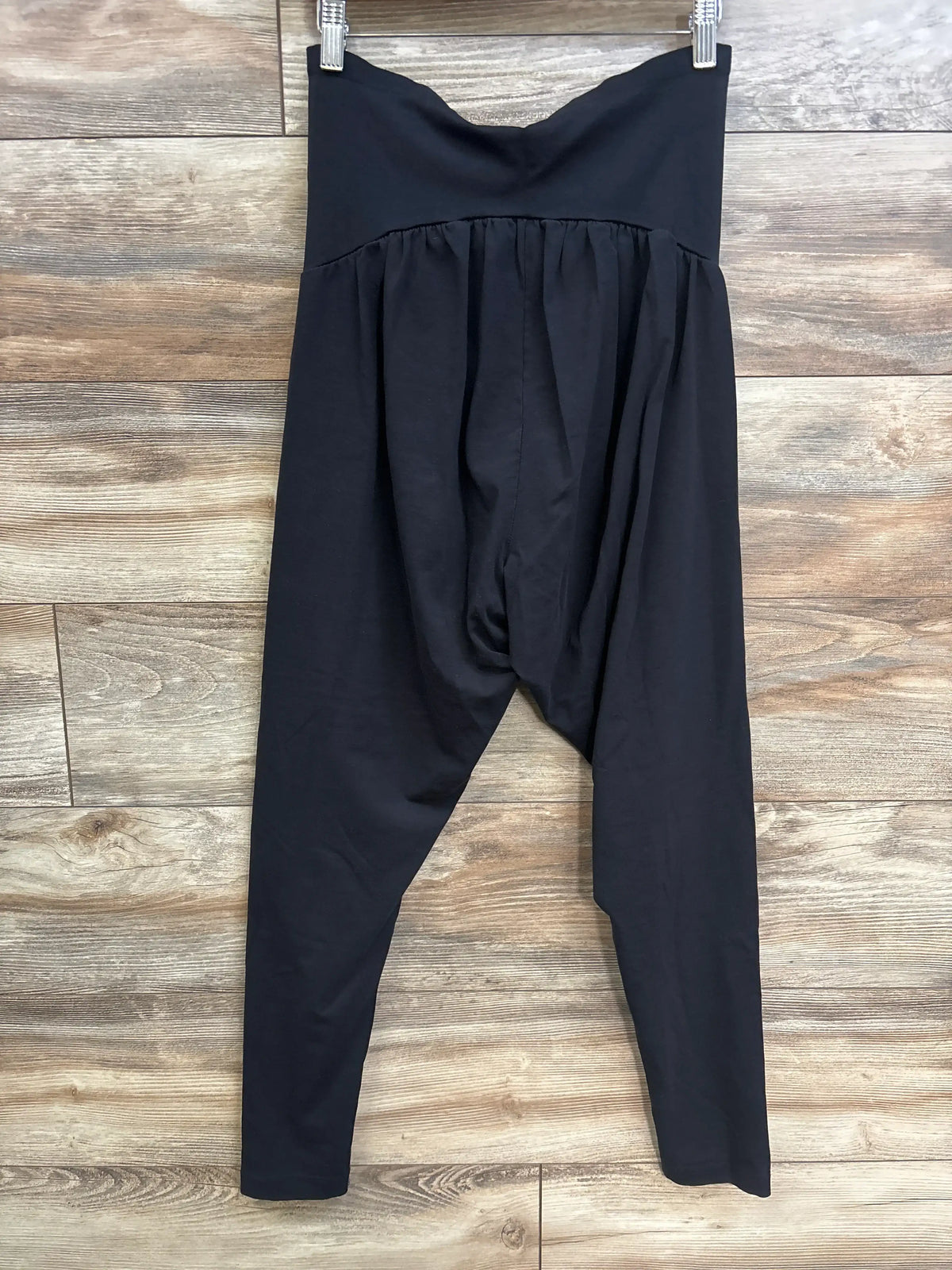 Motherhood Maternity full panel black leggings in size XL displayed against a wood background.