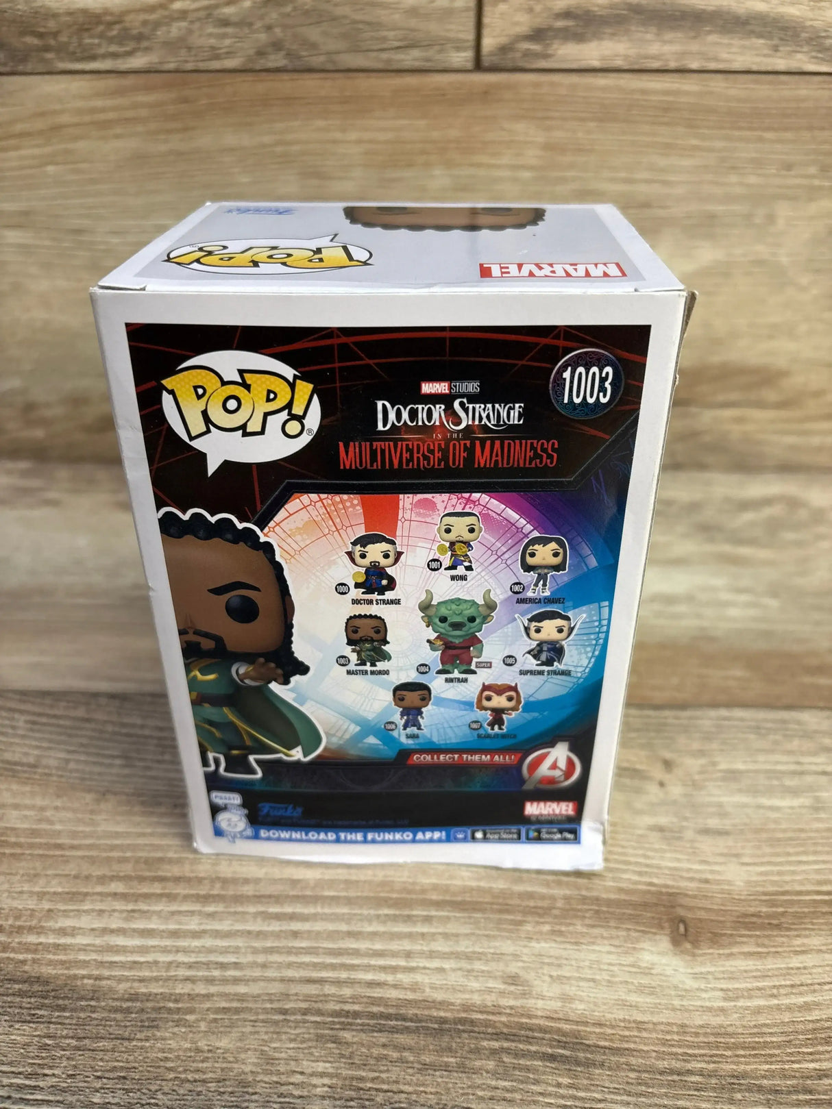 Three-quarter rear view of Funko Pop box Master Mordo showcasing back-panel artwork and character lineup on a wood surface