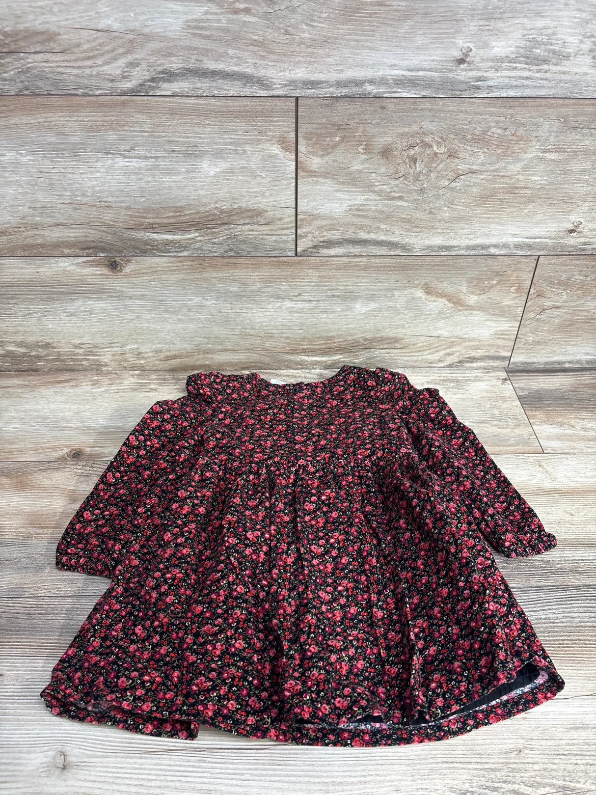 Girls long sleeve black floral dress with pink and red flowers on wood background
