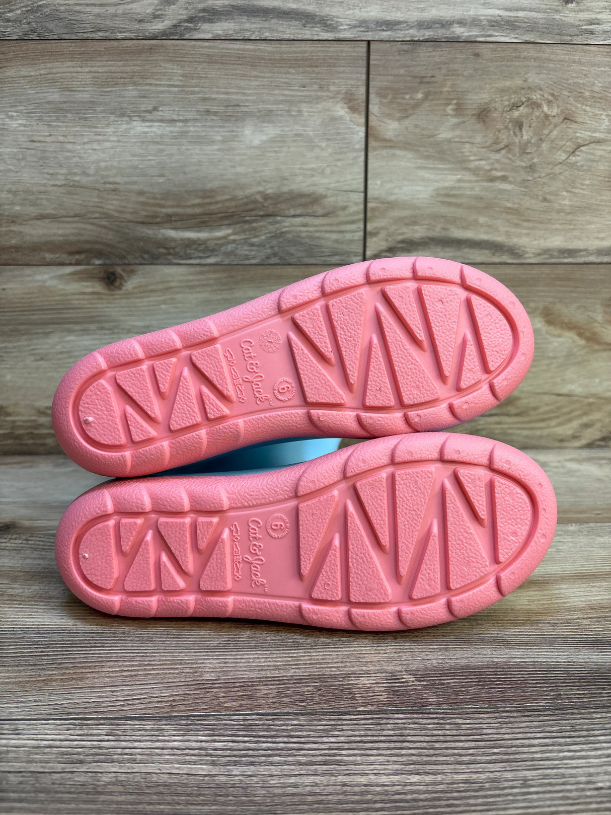 Pair of pink sole kids shoes, Cat & Jack size 6, on wooden floor