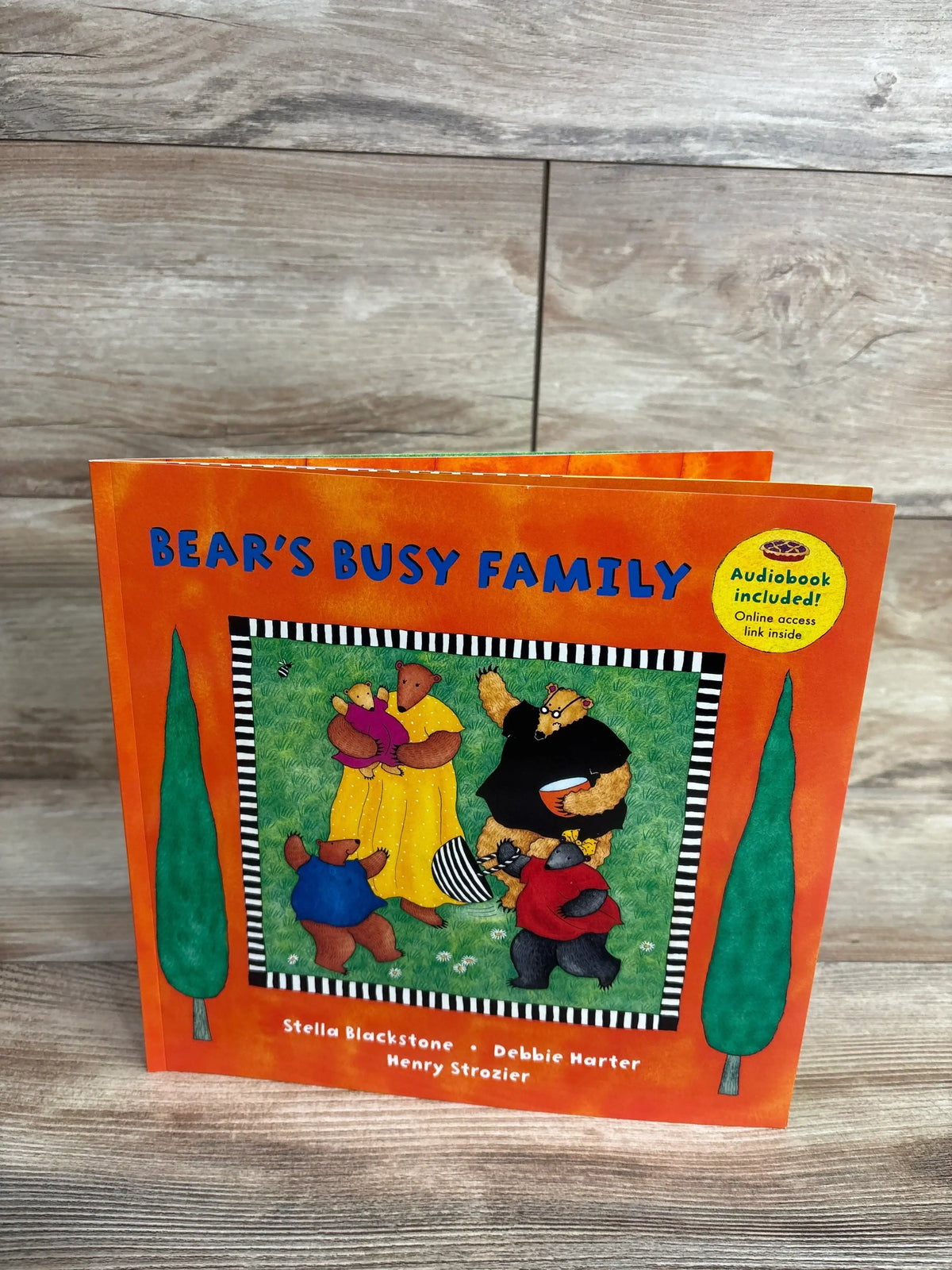 Bear's Busy Family children's book with orange cover and illustrated bears playing on grass