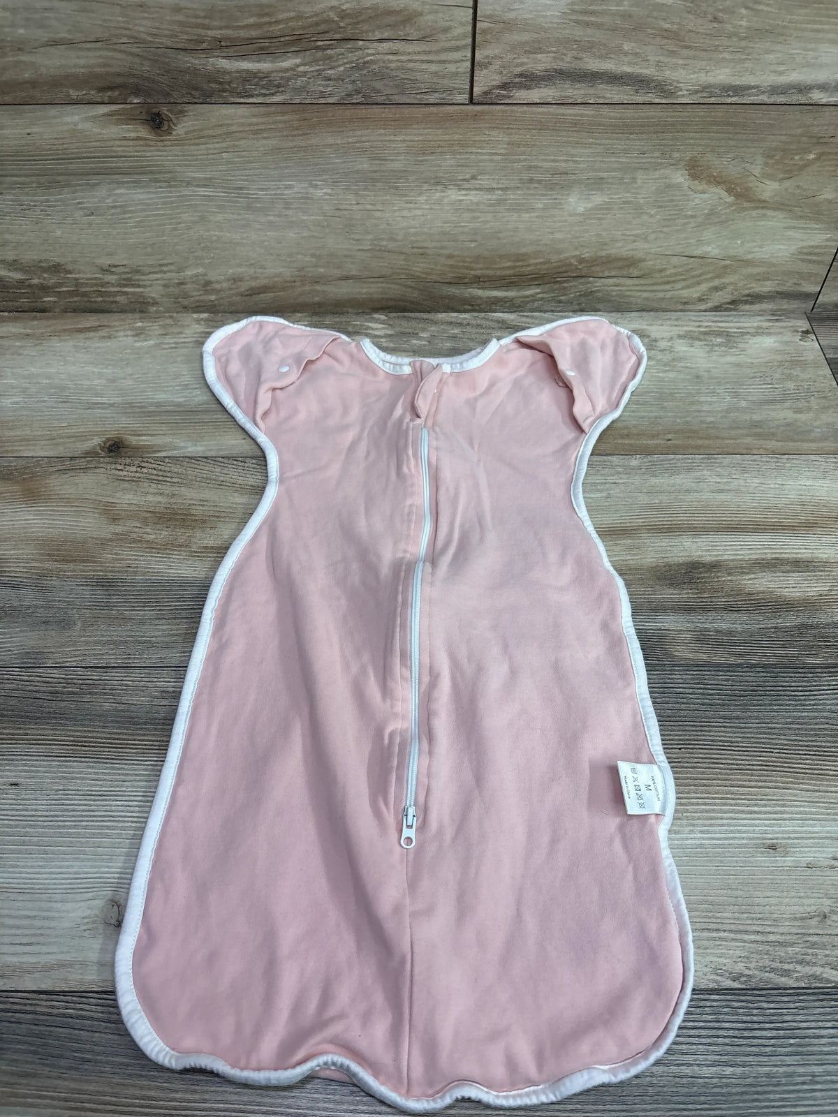 Pink Arms Up Swaddle for infants size 3-6m by Me n Mommy To Be on a wooden floor