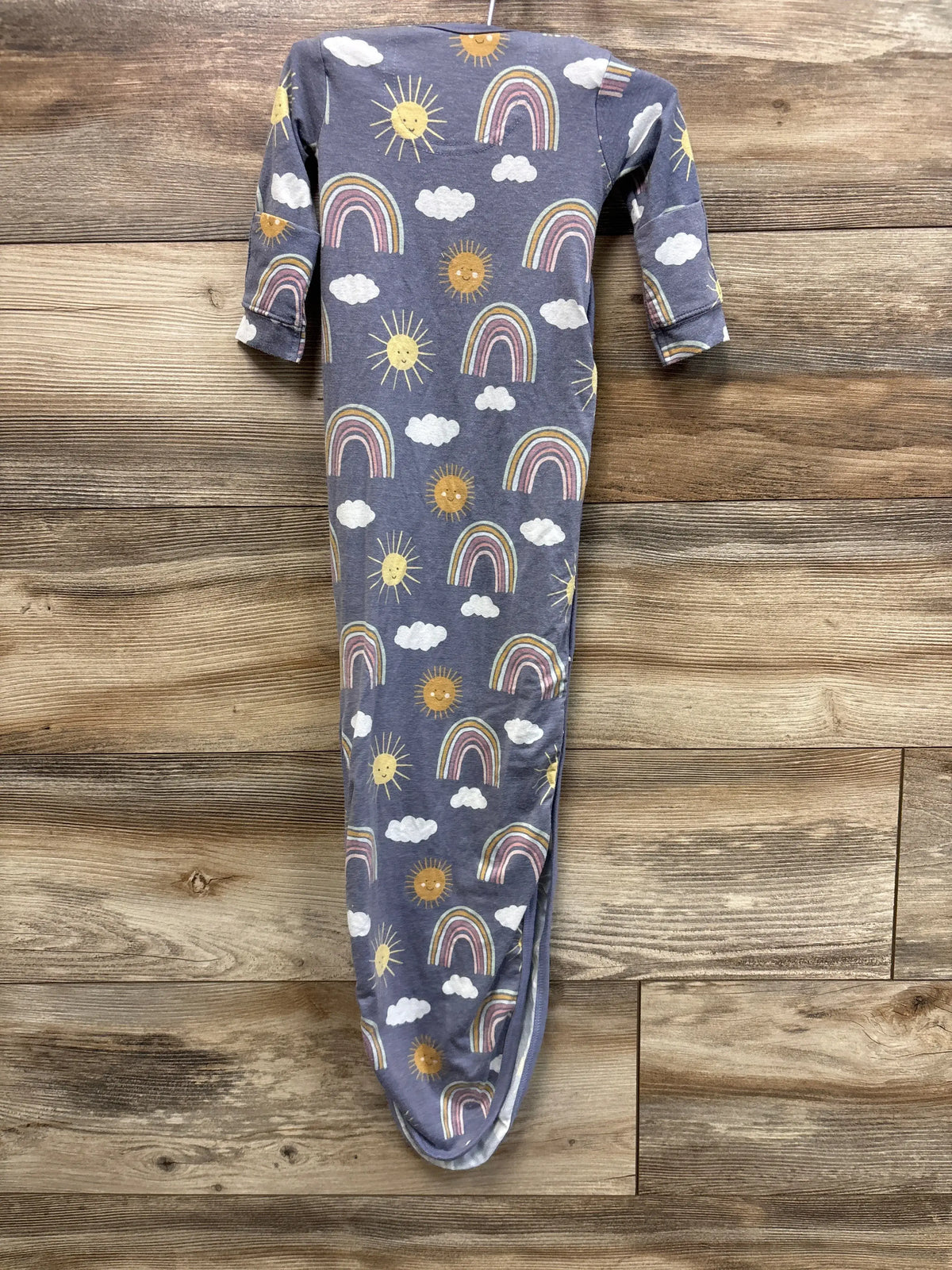 Front view of Copper Pearl purple rainbow print knotted gown showcasing long sleeves and knotted hem on a wood surface