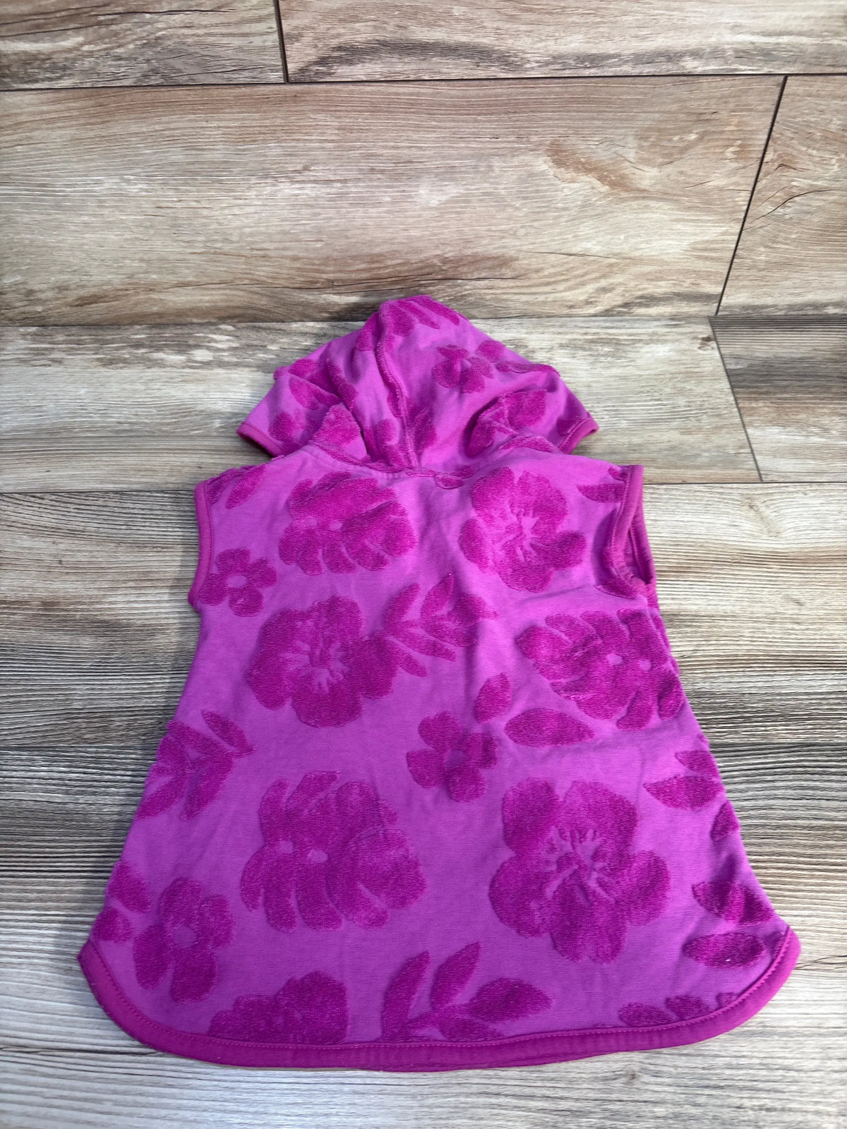 Back view of Cat & Jack purple terry cloth swim cover up in size 12 months, showing hood and floral pattern on a wood floor