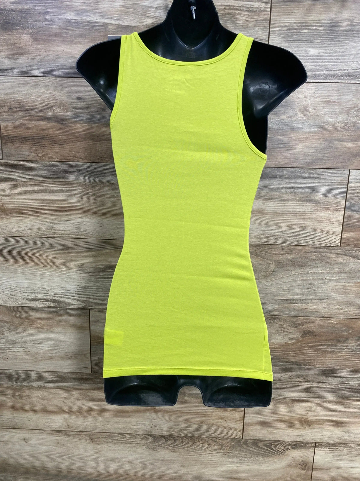 Front view of Isabel maternity tank top in lime showcasing fitted stretchy silhouette and high round neckline on black mannequin with wood-plank background