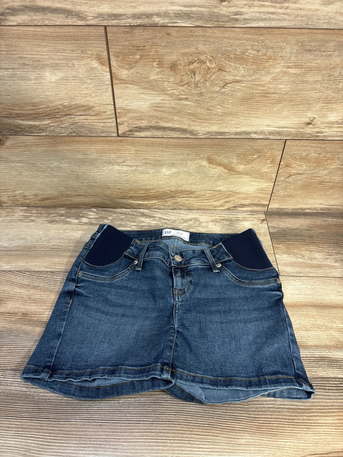 Front view of Gap maternity 4-inch inset-panel denim shorts showcasing dark wash blue stretch denim and faux front pockets