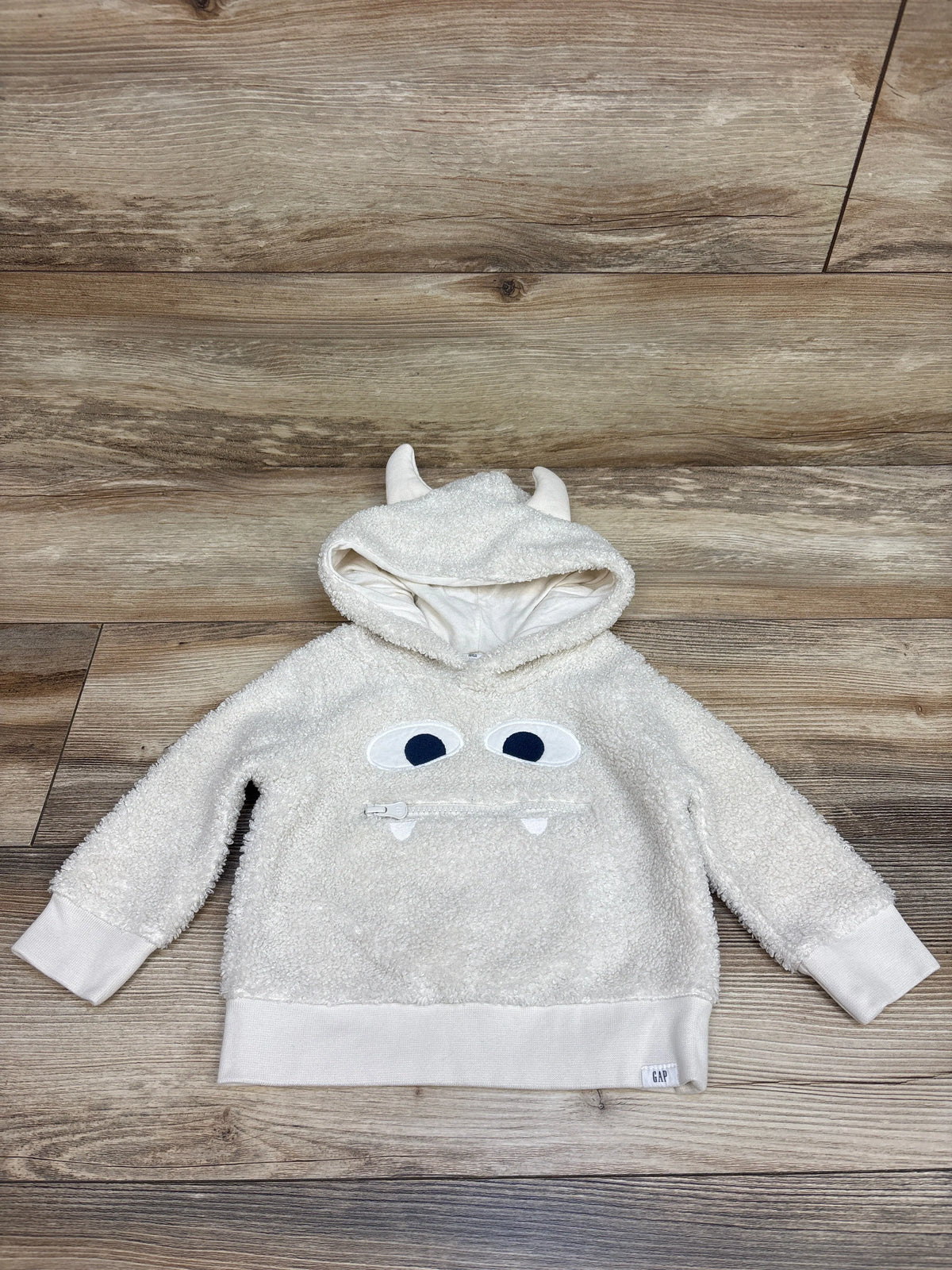 Front view of Baby Gap white sherpa monster 3D hoodie, size 12 to 18 months, with horned hood and zipper mouth
