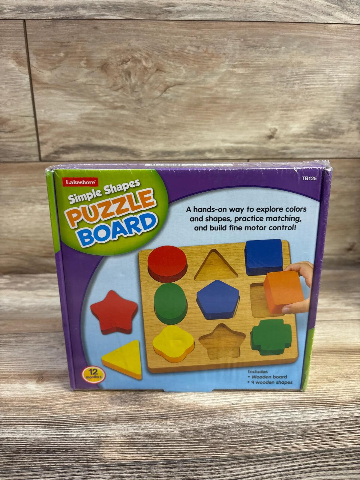 Front view of Lakeshore Simple Shapes Puzzle Board showcasing colorful wooden shapes and matching slots in purple packaging