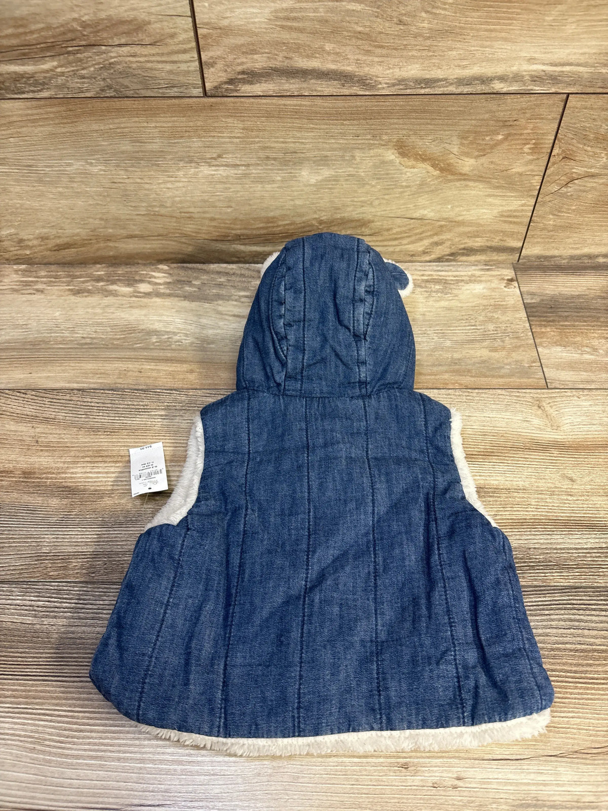 Back view of a blue quilted denim baby bear vest with white faux shearling trim