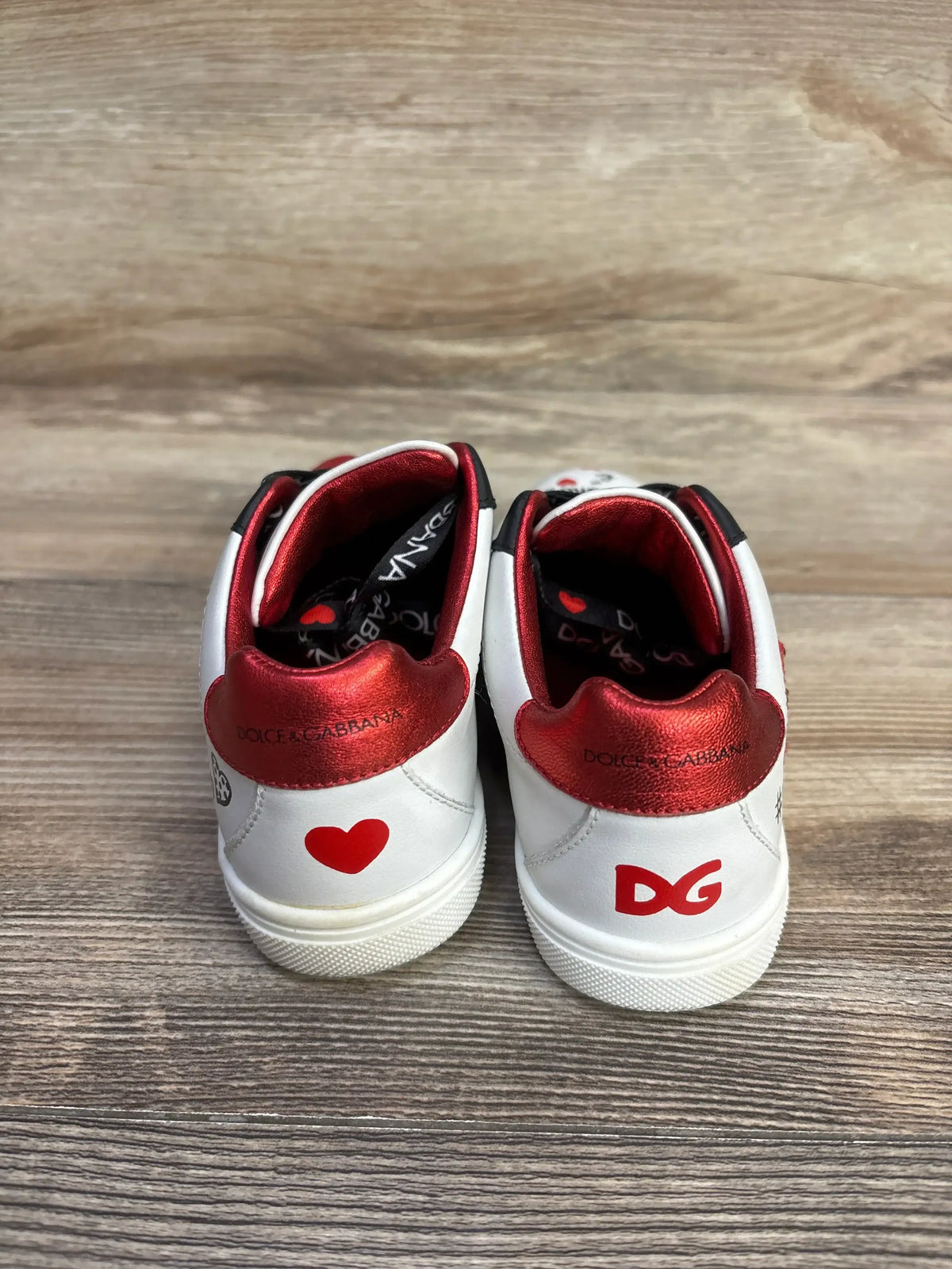 Rear view of Portofino DG Amore calfskin sneakers showing white uppers, red collars, heart and DG graphics