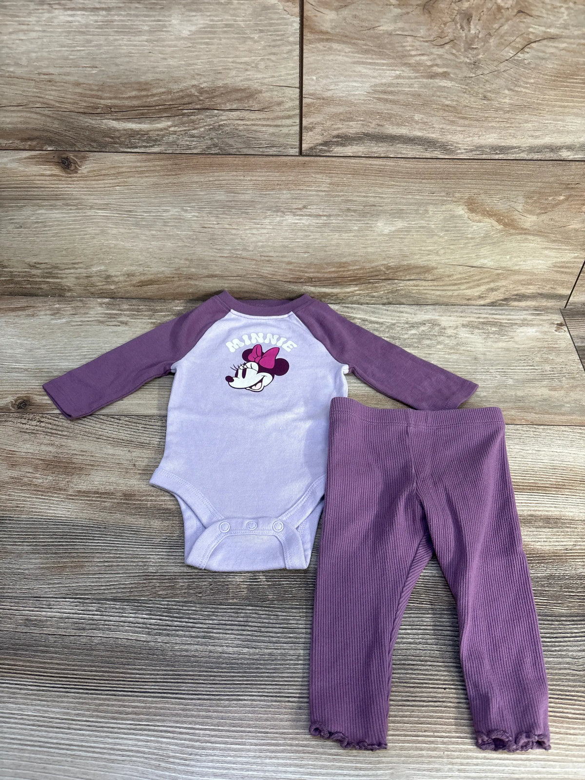 Front view of purple Jumping Beans Disney Minnie Mouse bodysuit and ribbed bottoms set with snap closures