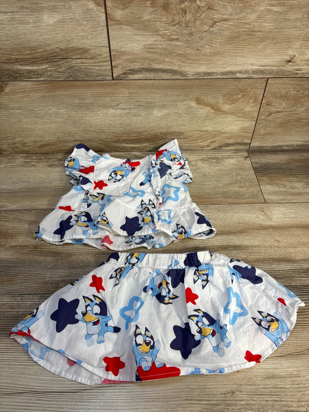 Kids' cartoon Bluey print summer top and skirt set on wood background