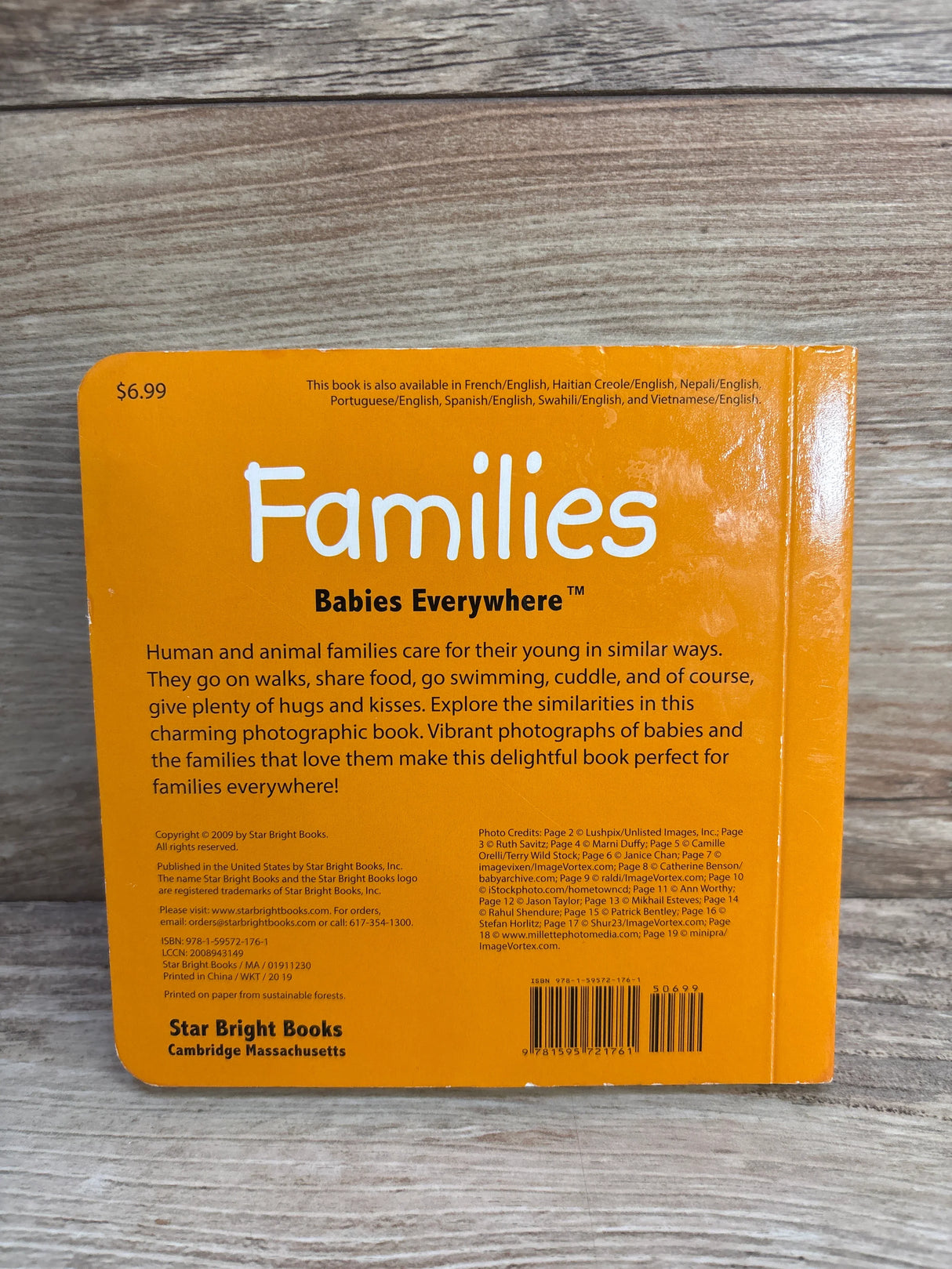 Back cover of Families Babies Everywhere children's book with orange background and product details