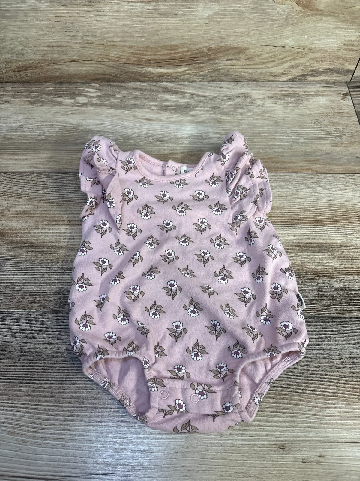 Front view of pink Rabbit + Bear organic floral bubble romper showing puff sleeves and gathered bubble legs on a white background