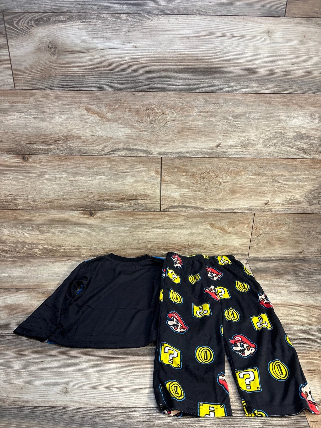 Black kids pajama set with long sleeves and Mario-themed pants featuring coins and question blocks