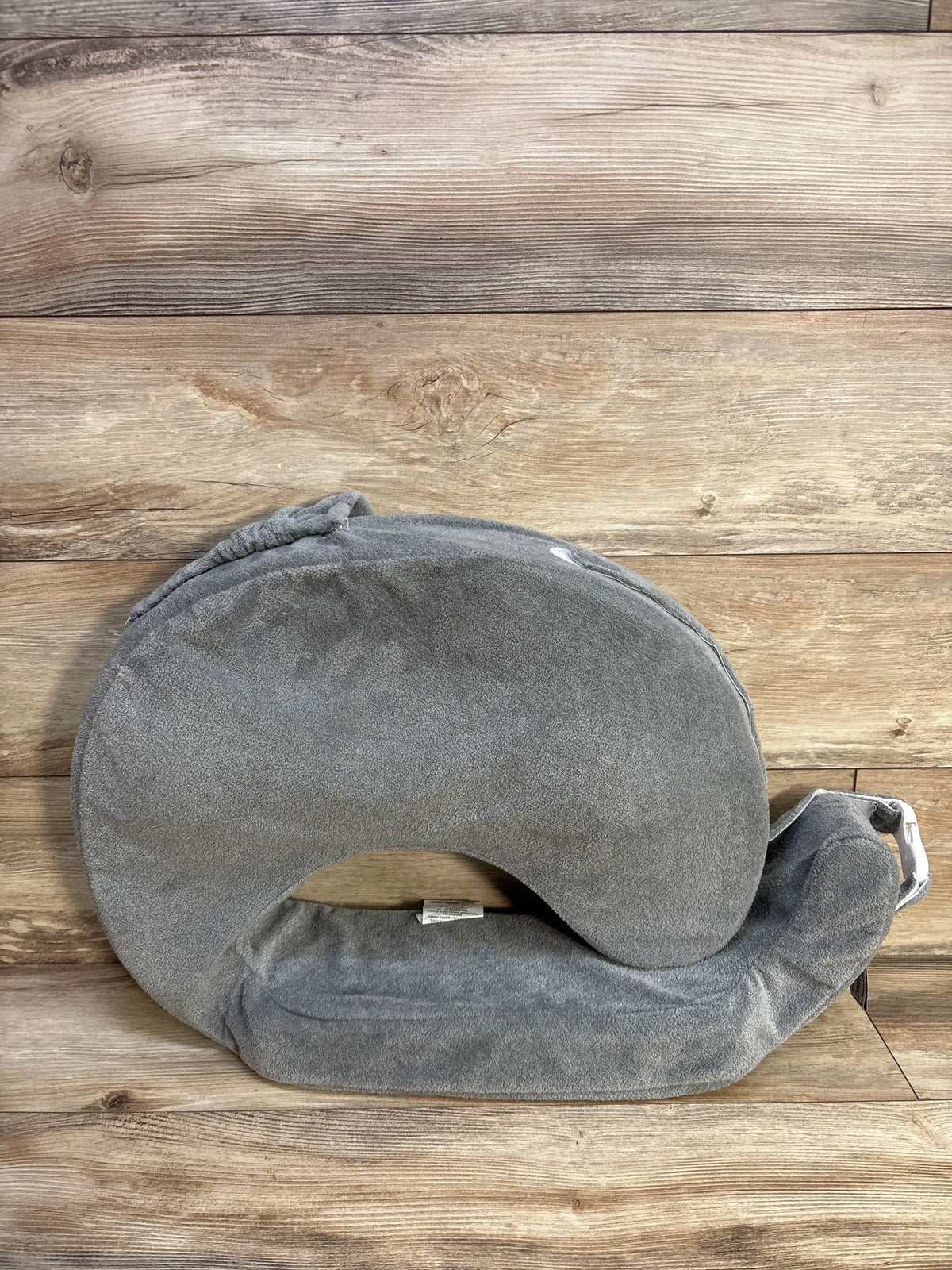 Front view of My Brest Friend nursing pillow slipcover showcasing its gray cover with a wood plank background