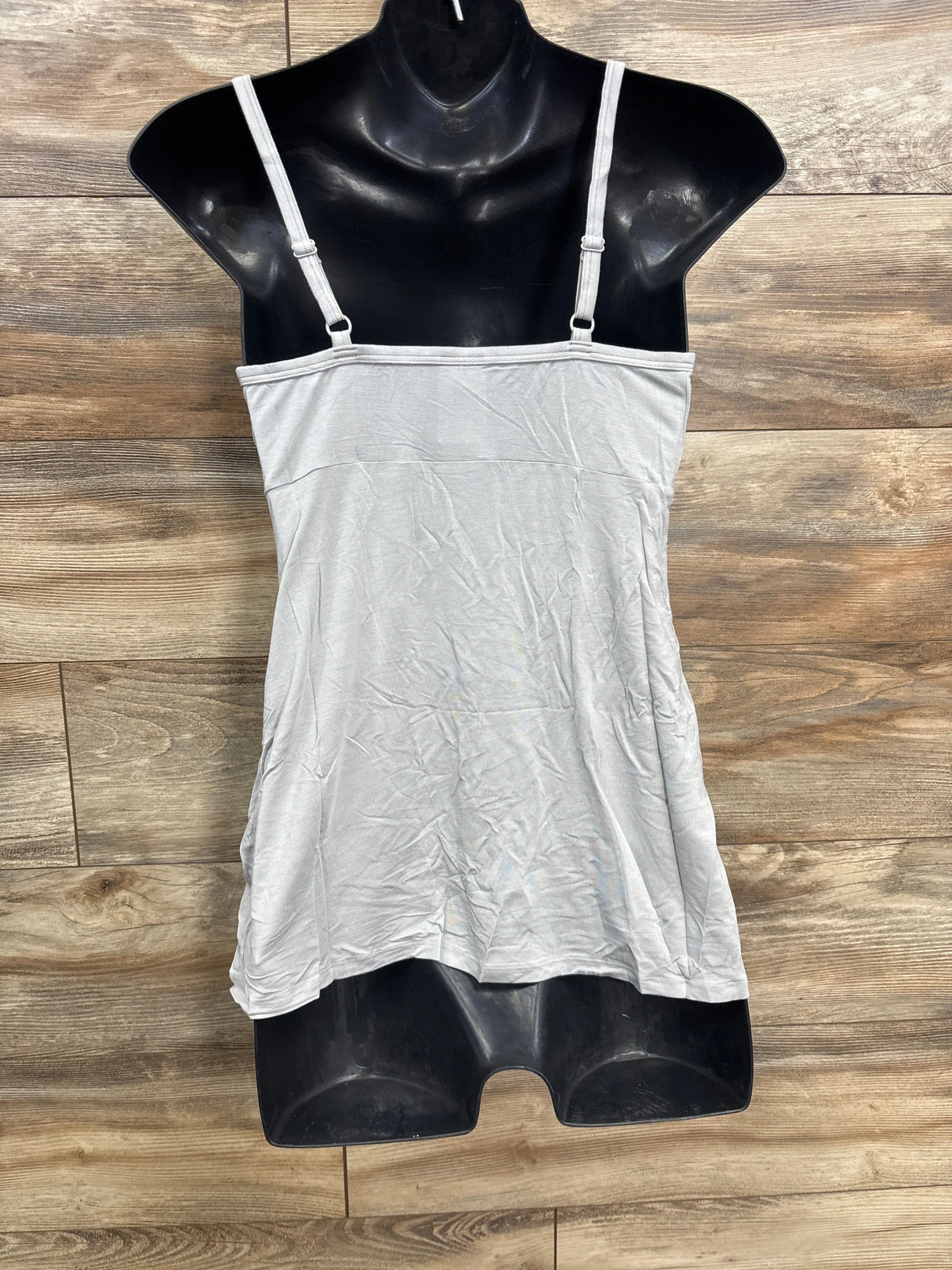 Light gray adjustable strap camisole top on black mannequin with wood background