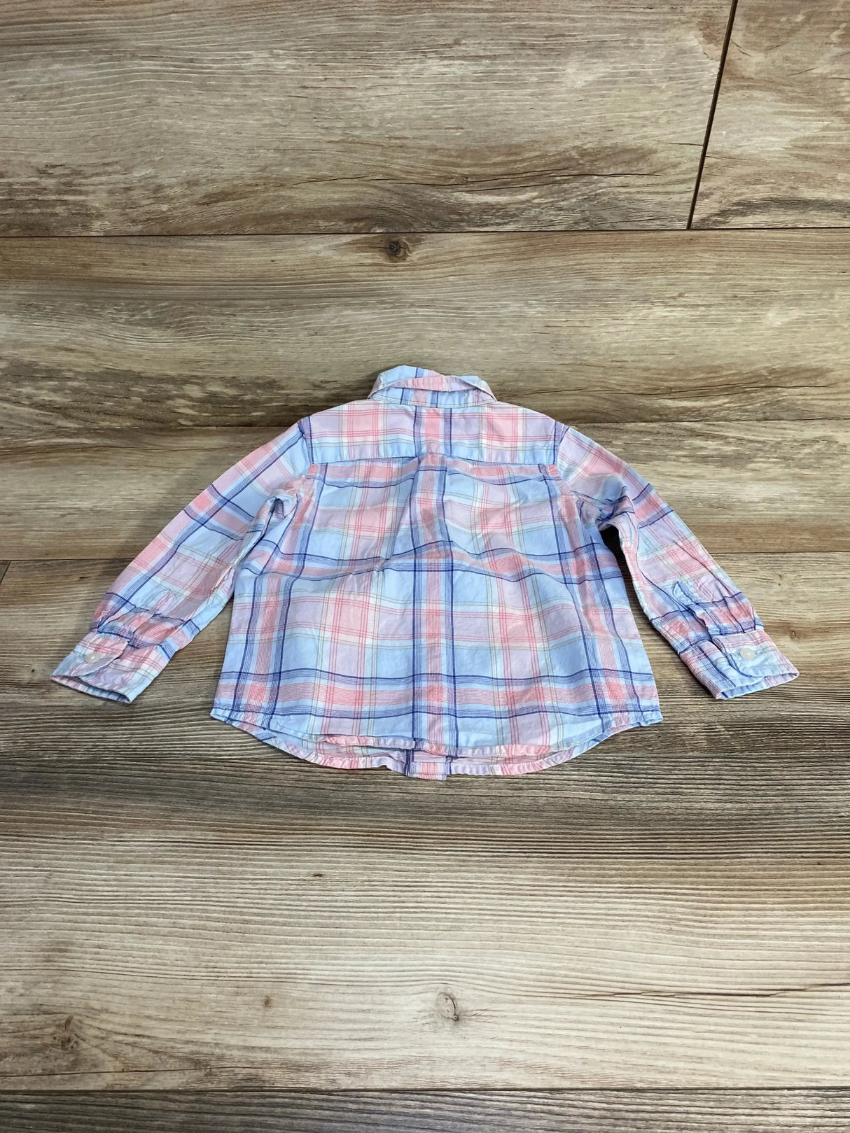 Back view of Janie and Jack Plaid Button Down Shirt in blue pink and white plaid with long sleeves on wood plank floor