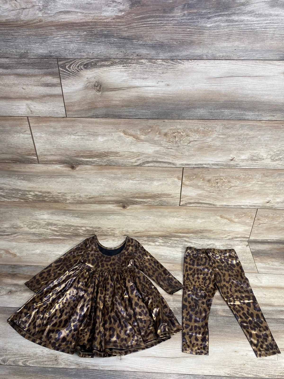 Leopard print long-sleeve dress and matching leggings set on wooden floor
