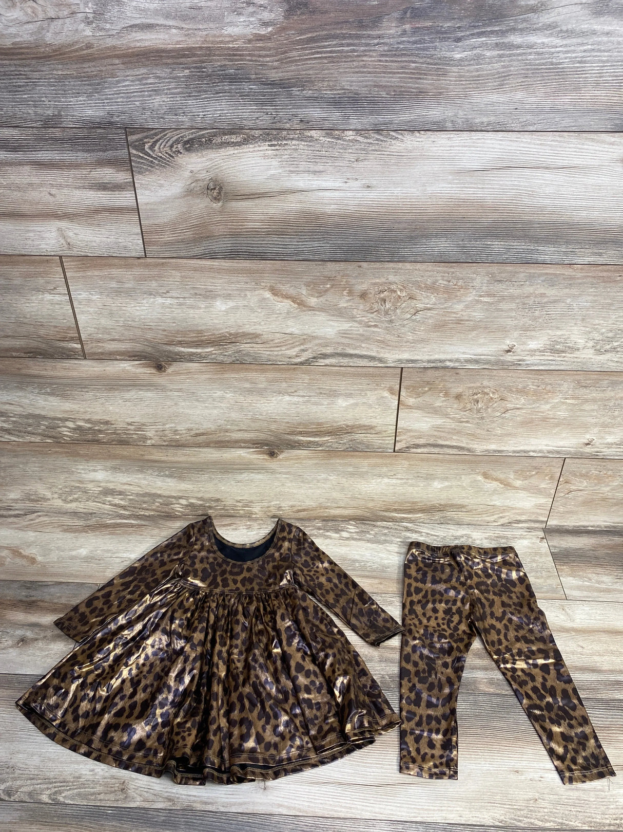 Leopard print long-sleeve dress and matching leggings set on wooden floor