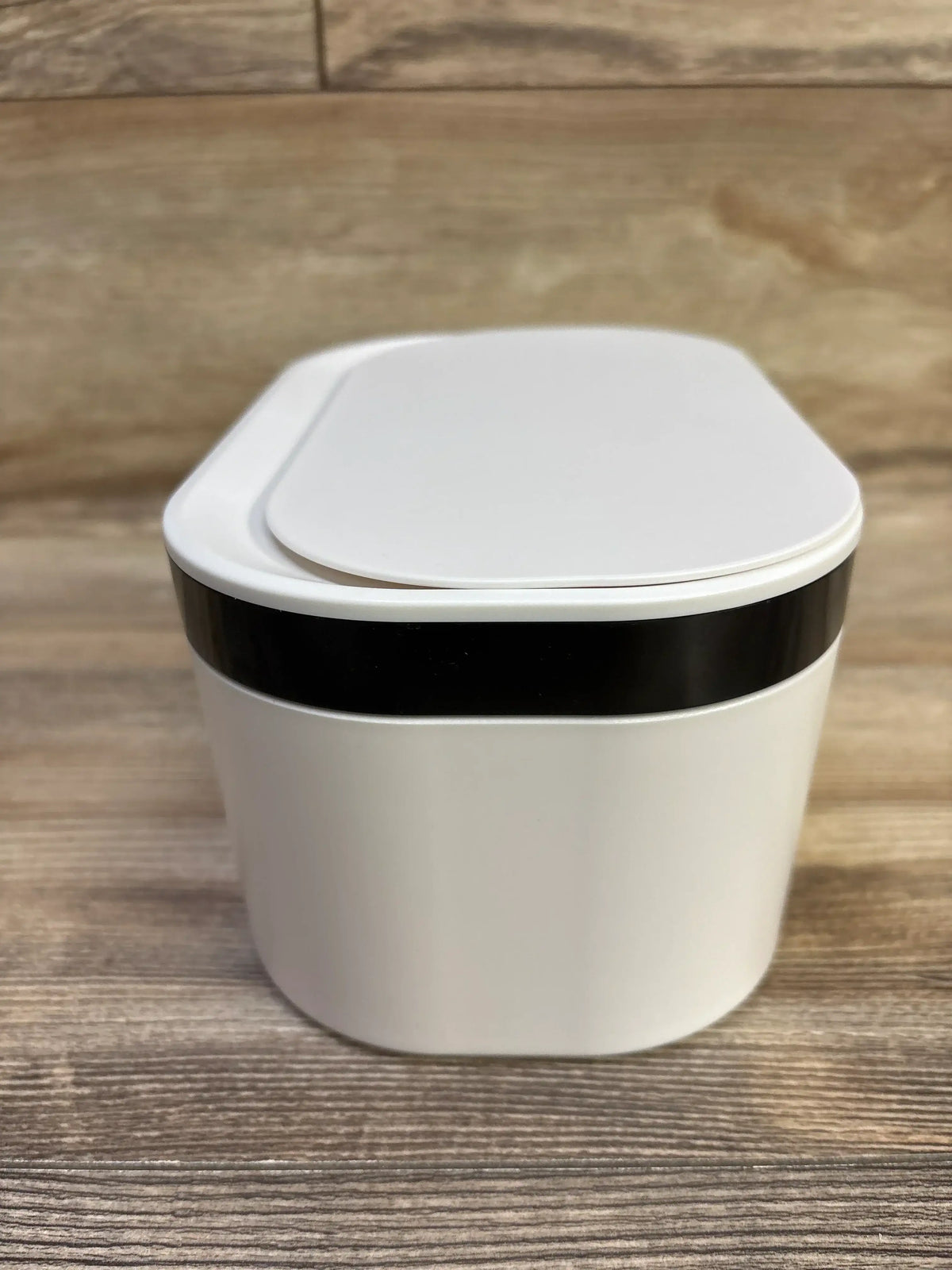 Front view of ZJchao USB baby wipes heater showing closed lid and black LED band on wooden surface