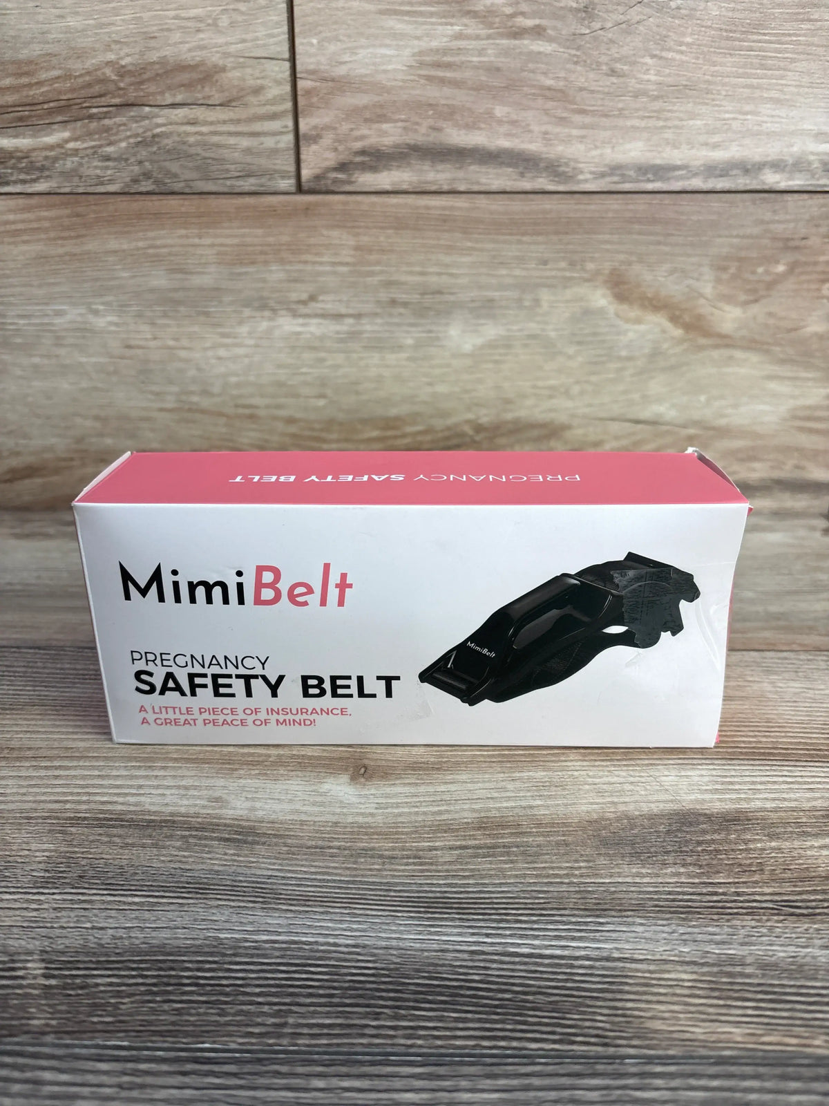 Front view of MimiBelt pregnancy safety belt box showcasing black adjustable belt with wood-grain background