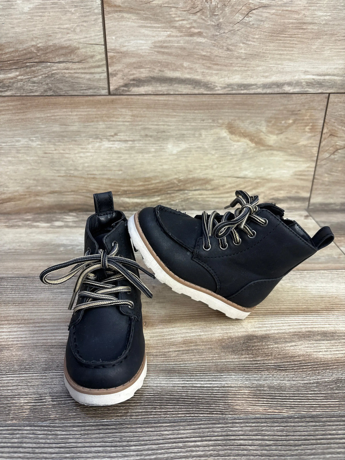 Front and side view of Cat & Jack Greyson black boots in size 6C showcasing bungee laces and hook and loop velcro closure on a wood floor