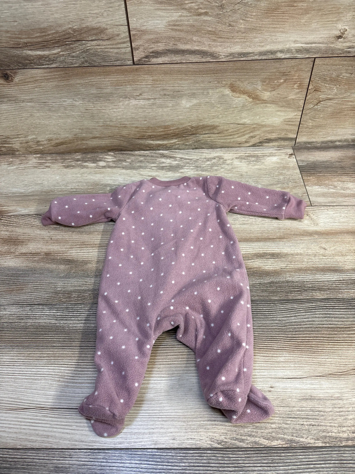 Just One You mauve polka dot newborn blanket sleeper on a wooden background