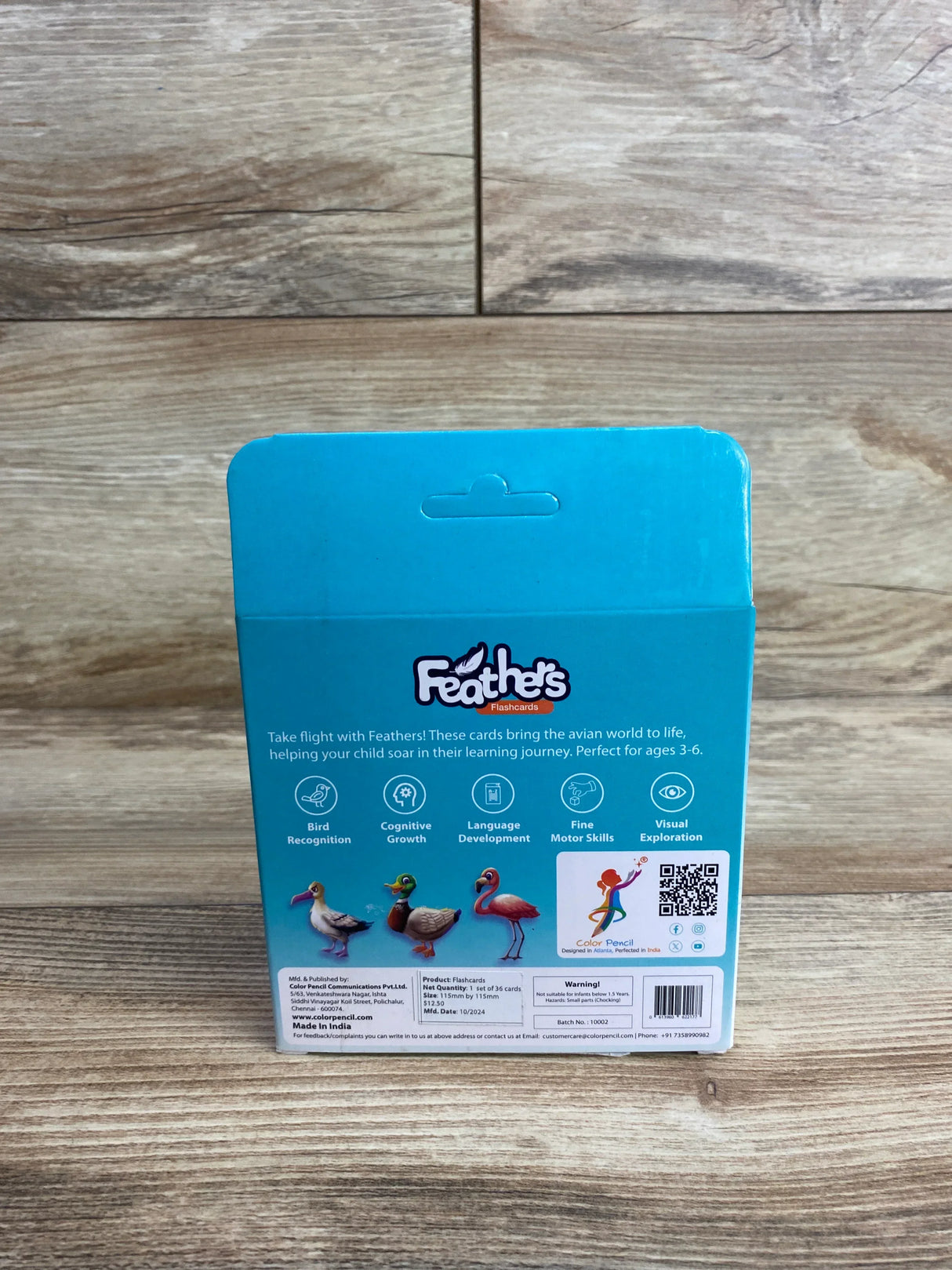 Feathers flashcards box for kids with bird illustrations and educational benefits on wood floor