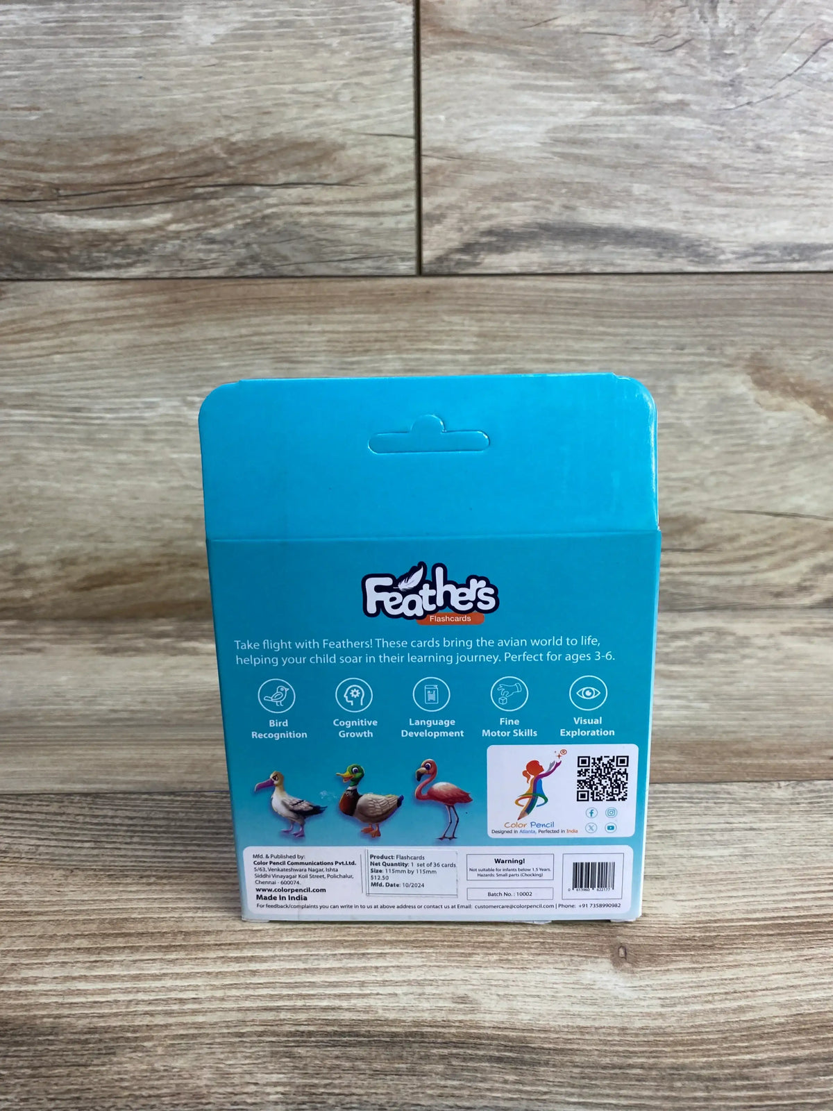 Feathers flashcards box for kids with bird illustrations and educational benefits on wood floor
