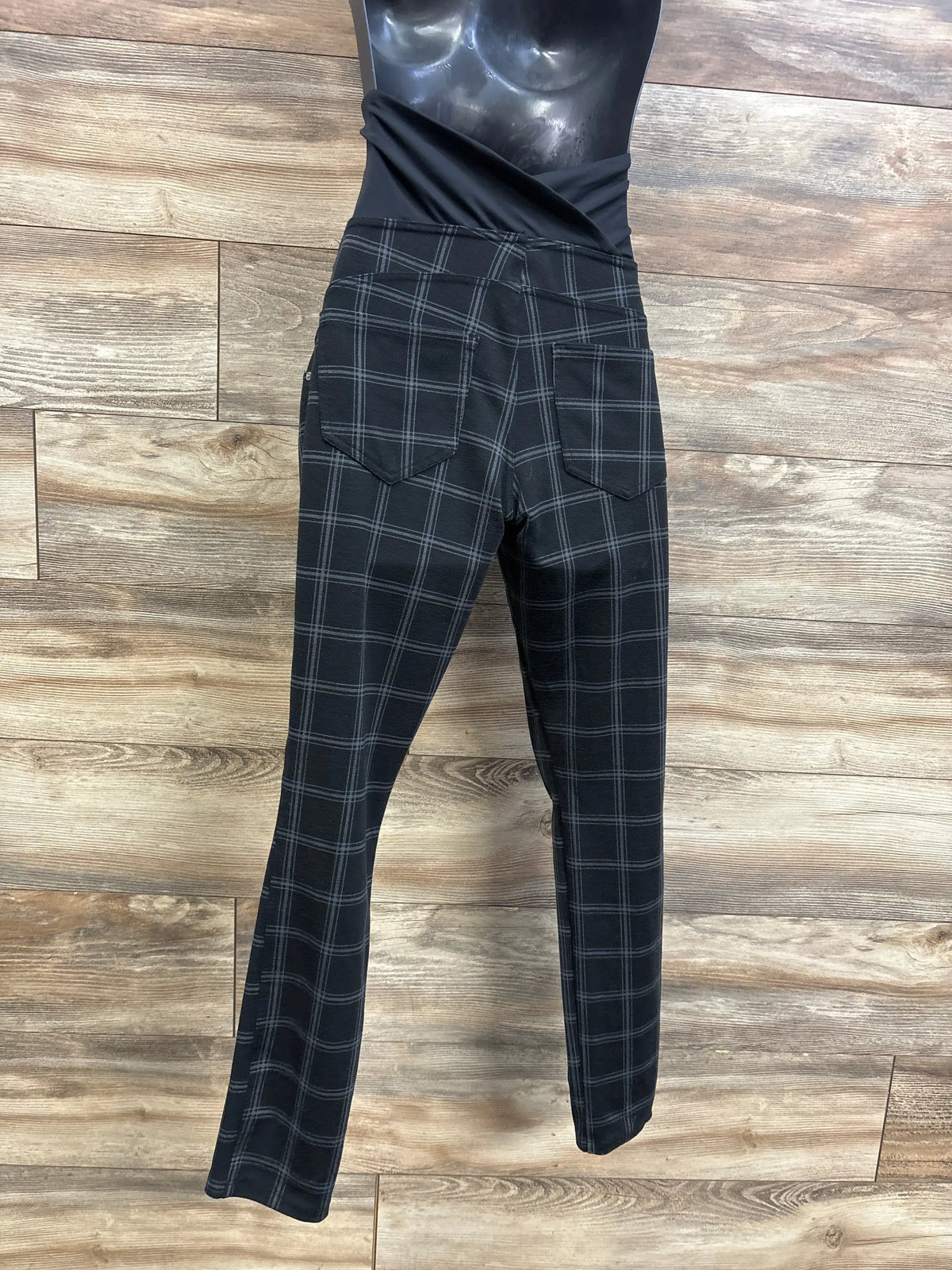 Rear view of Isabel Maternity crossover panel pants showcasing black plaid fabric, back pockets, and crossover waistband on a mannequin