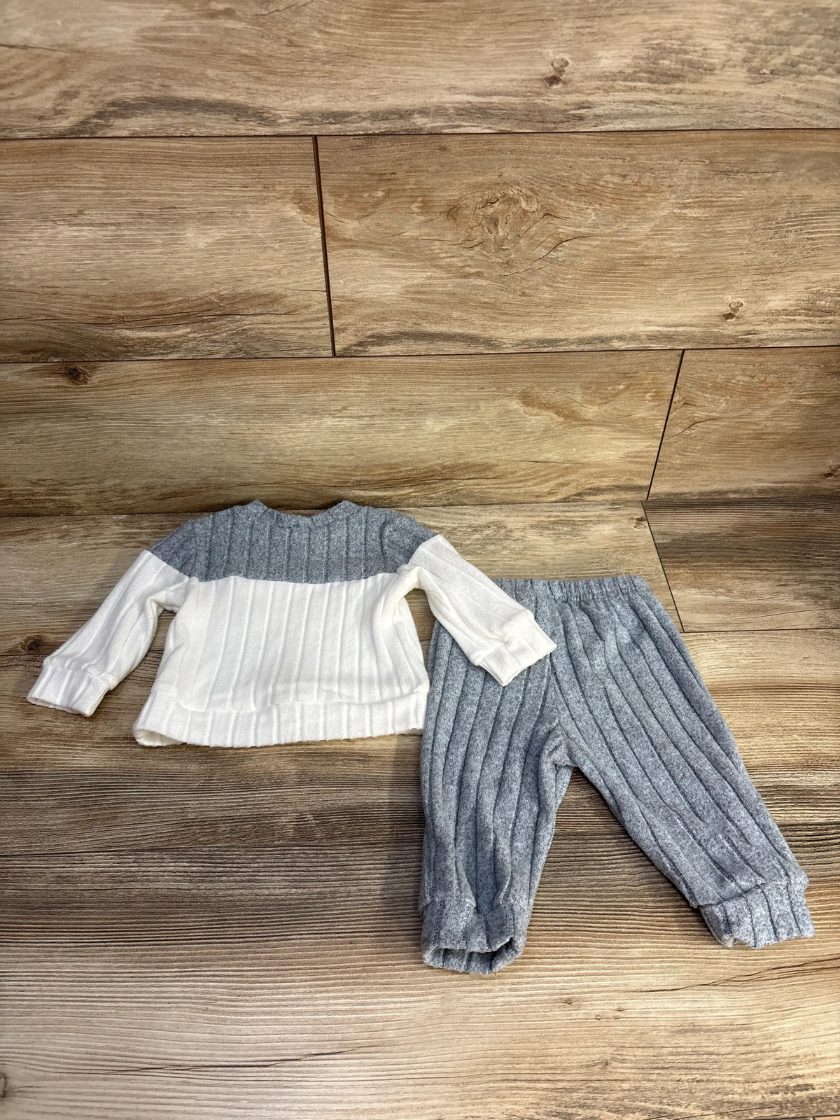 Overhead view of Shein 2pc shirt and pants set showing ribbed texture and grey pants on a wood background