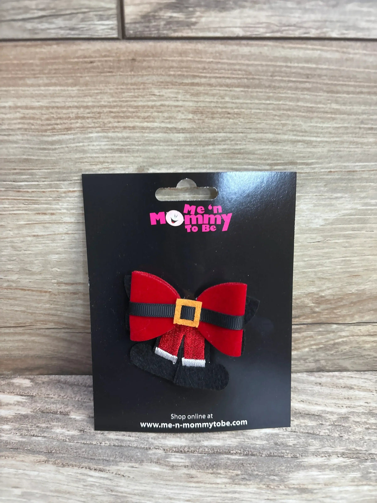 Red Santa-themed baby hair bow with black belt and gold buckle on black card