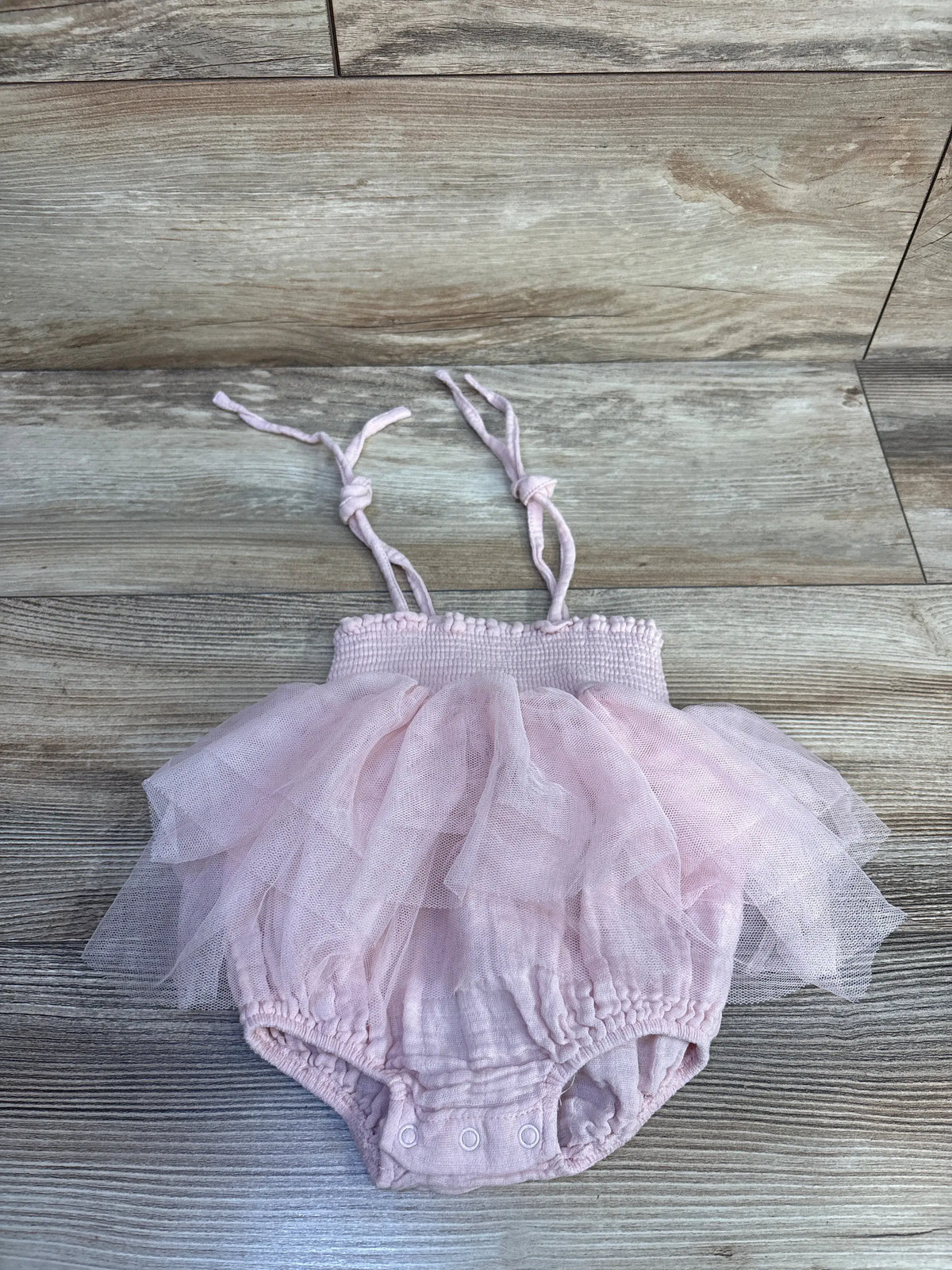 Front view of Tullabee pink smocked tutu bubble romper showcasing smocked bodice, layered tutu skirt, tie straps, and snaps