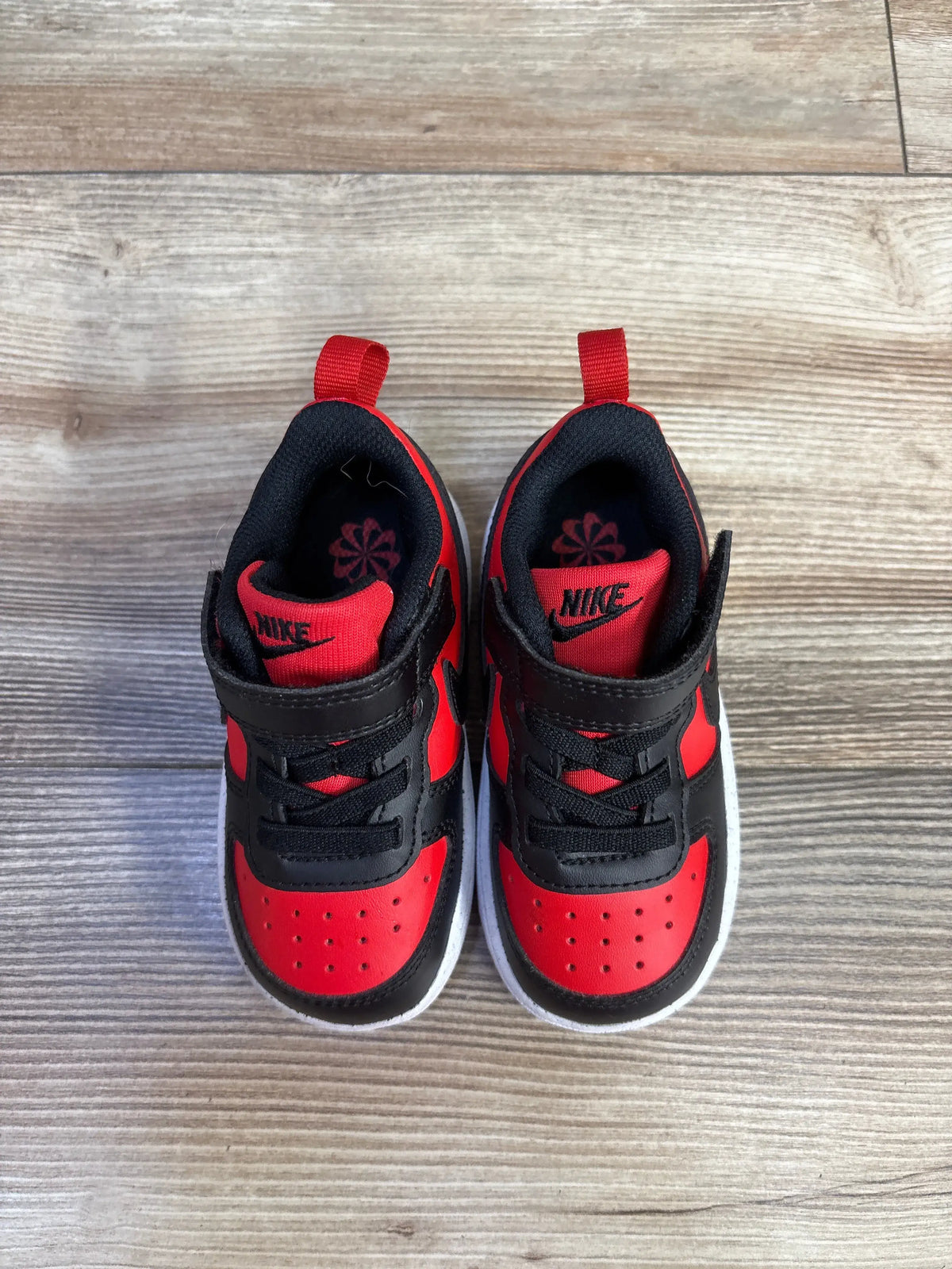 Top view of Nike Court Borough Recraft TD sneakers showcasing red and black color blocking, laces, and straps