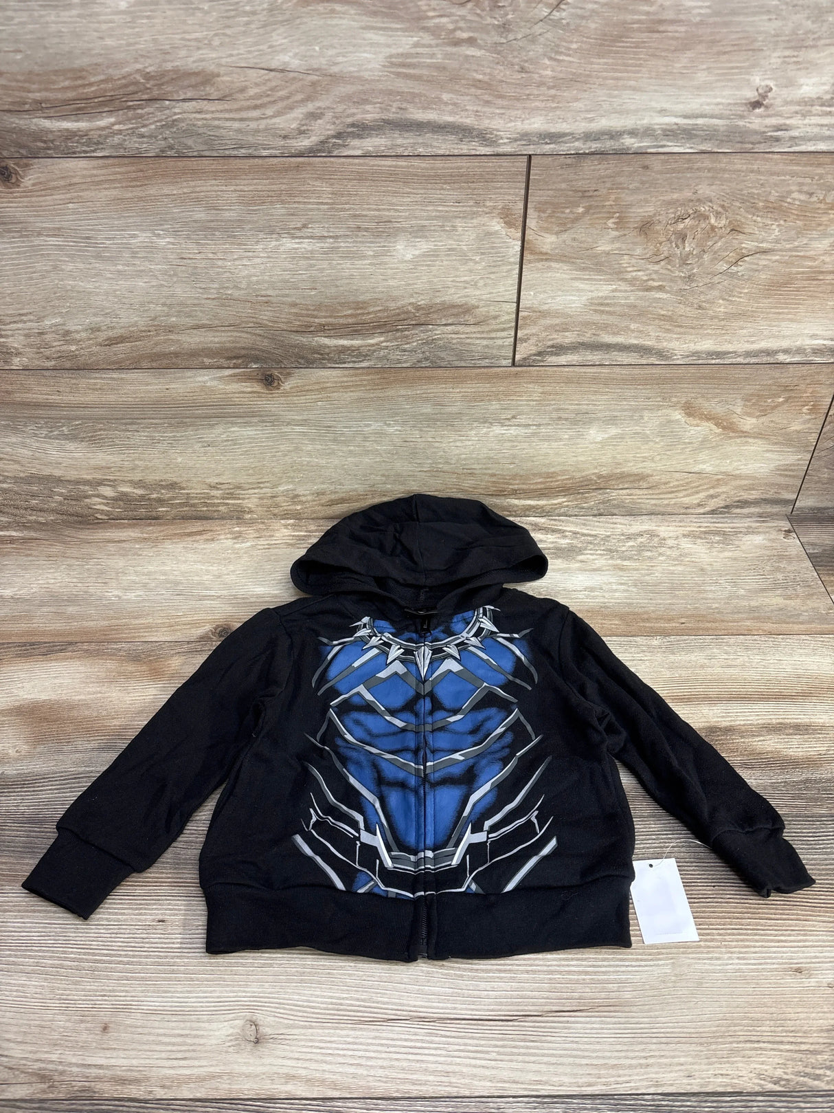 Kids black superhero zip-up hoodie with blue and silver chest armor design, laid flat.