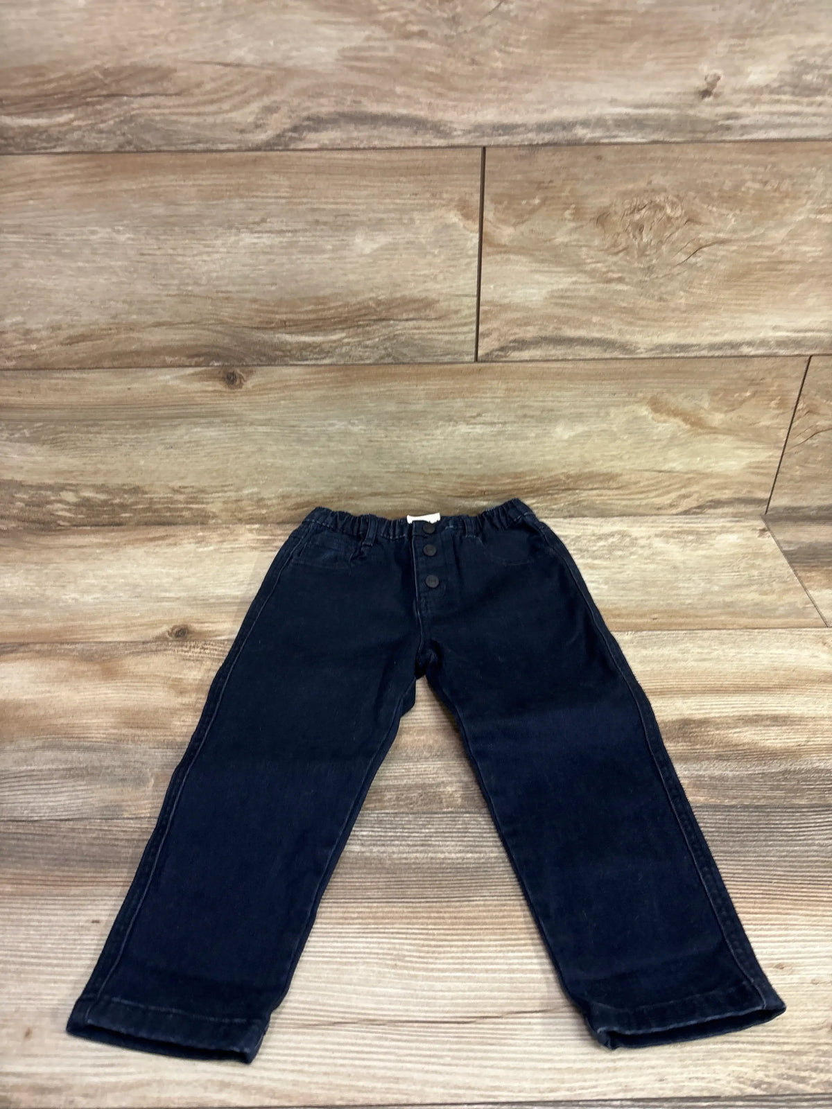 Easy Peasy dark wash navy blue jeans for toddlers size 3T on a wooden background