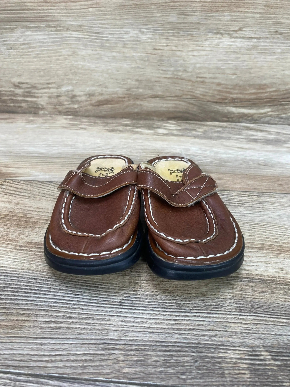 Three-quarter view of Tom Dog leather toddler clogs size 5/6C showing slip-on design and stitching on white background