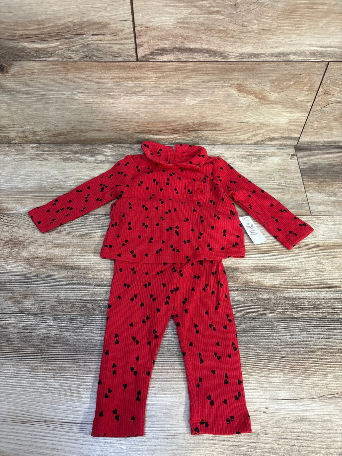 Front view of Baby Gap ribbed heart shirt and pants set showing red knit, heart print, Peter Pan collar on wood floor