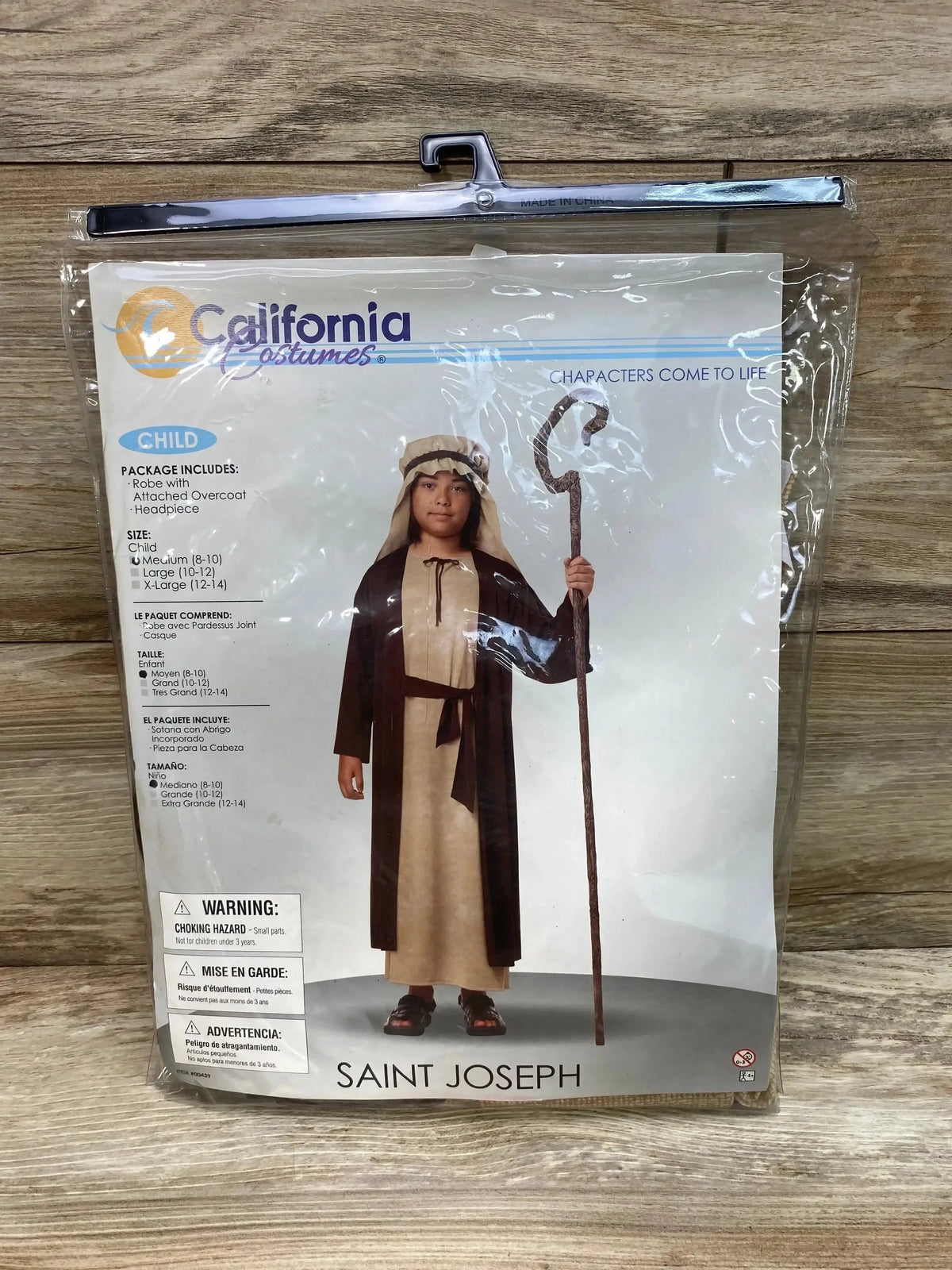 Front view of California Costumes Saint Joseph child costume package showing a robe, attached overcoat, headpiece, and medium size 8 to 10