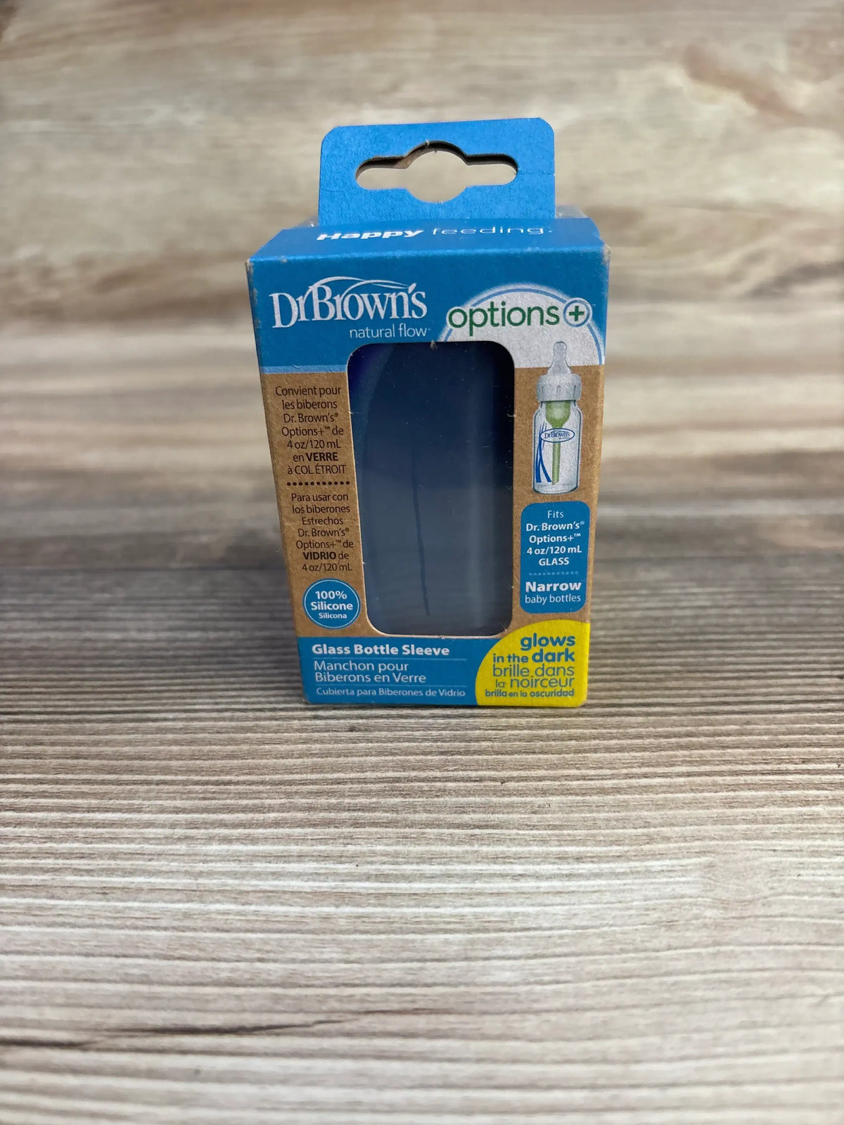 Front view of NEW Dr Browns glass bottle sleeve silicone narrow showcasing blue Options Plus retail packaging on wood plank floor