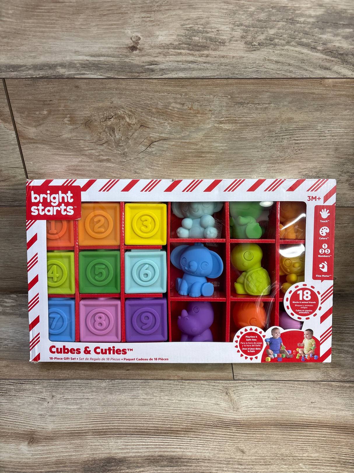 Front of Bright Starts Cubes & Cuties 18pc set showing colorful number blocks and pastel animals in window box on wood